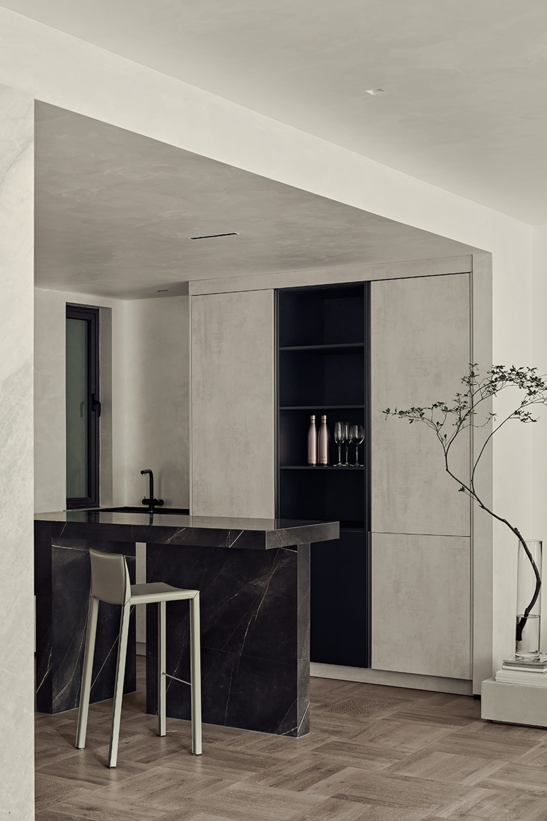 Modern kitchen with marble countertops and concrete cabinets