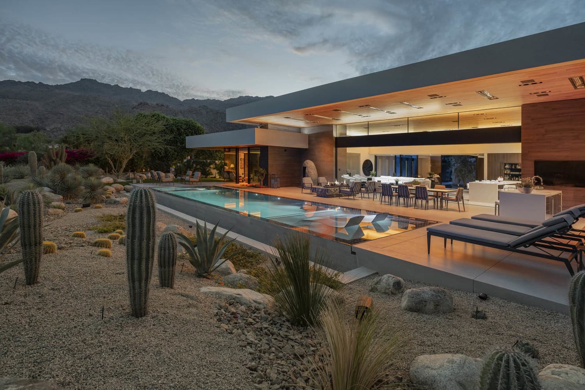 Modern residential exterior featuring sleek design with concrete, glass, and wood elements.