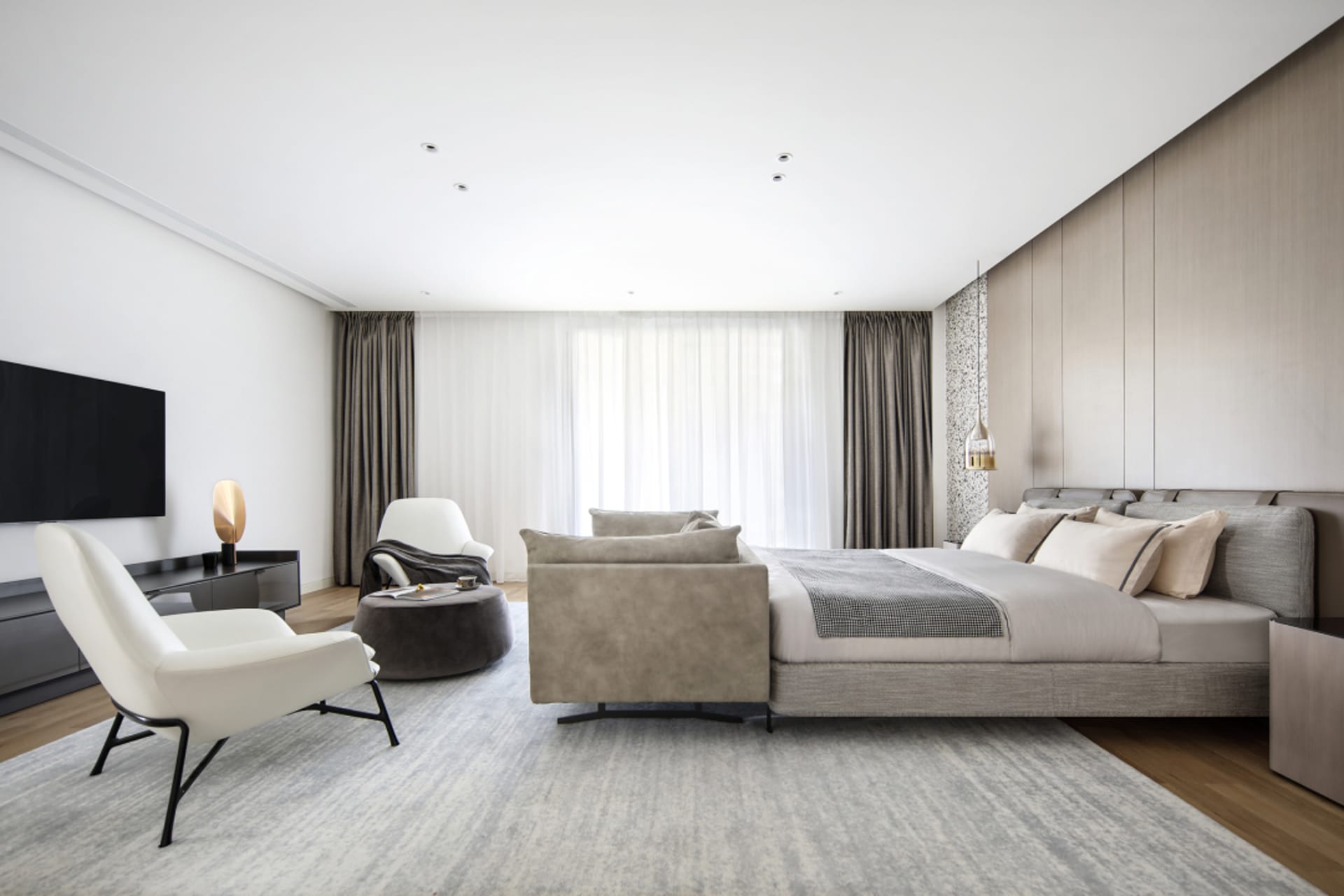 Modern minimalist bedroom featuring taupe leather furniture and beige curtains.