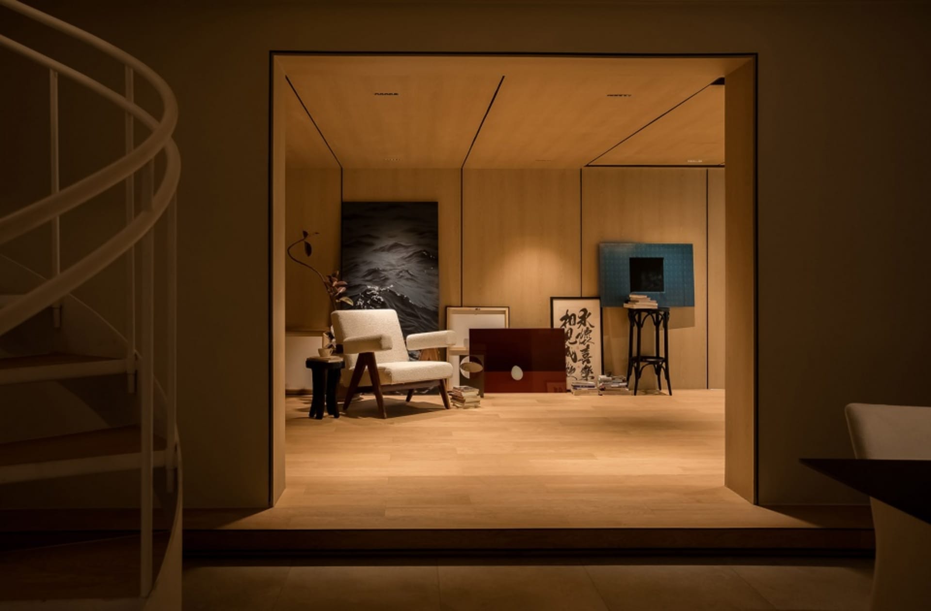 Minimalist living room with wooden furniture and a painting.