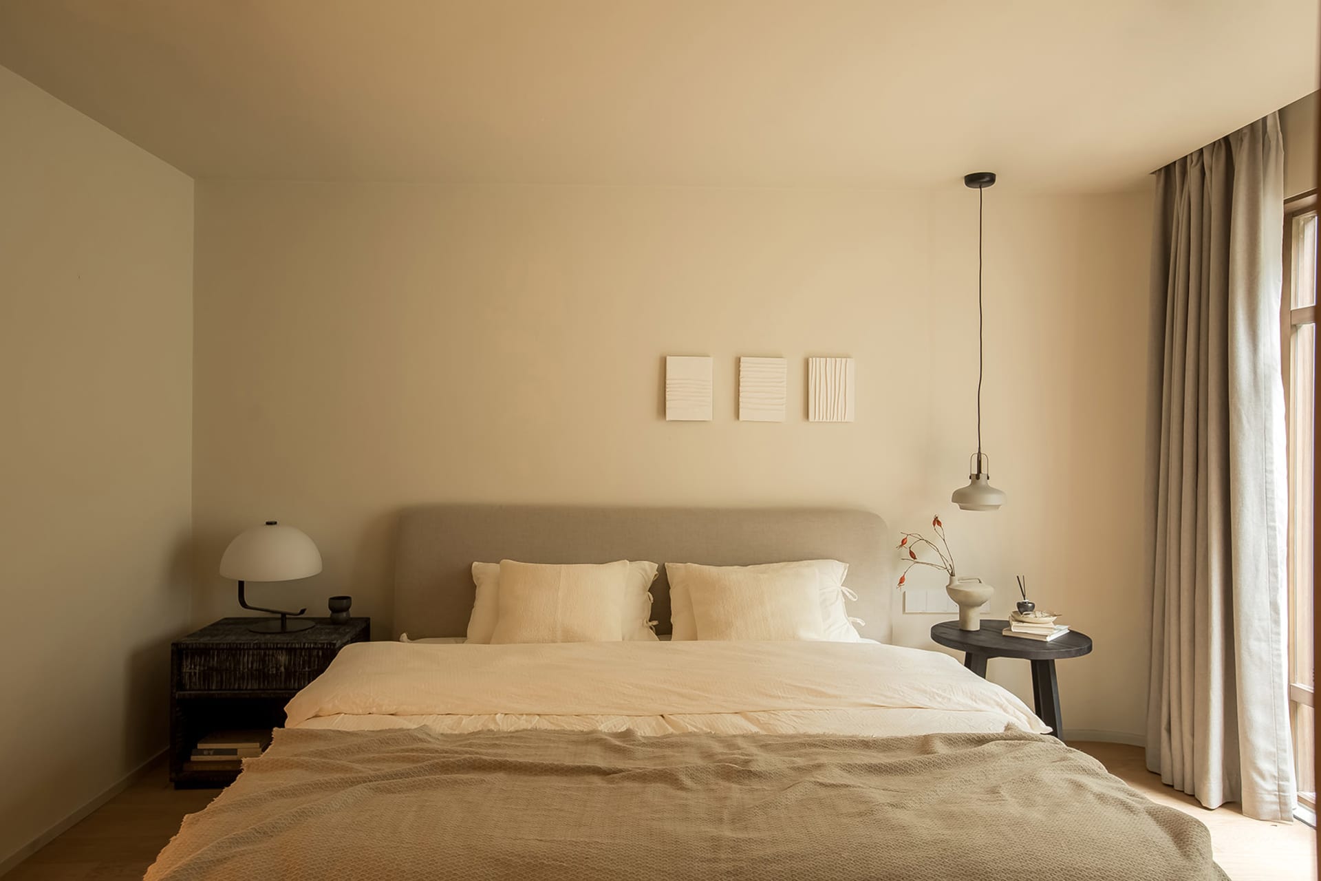 A minimalist bedroom with neutral tones and simple decor.