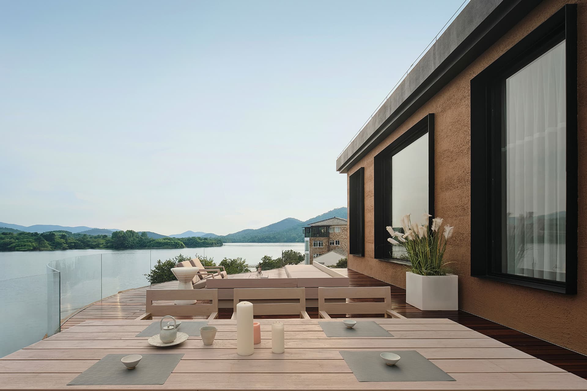 現代住宅露台採用木質、混凝土與玻璃材質,搭配湖景視野。