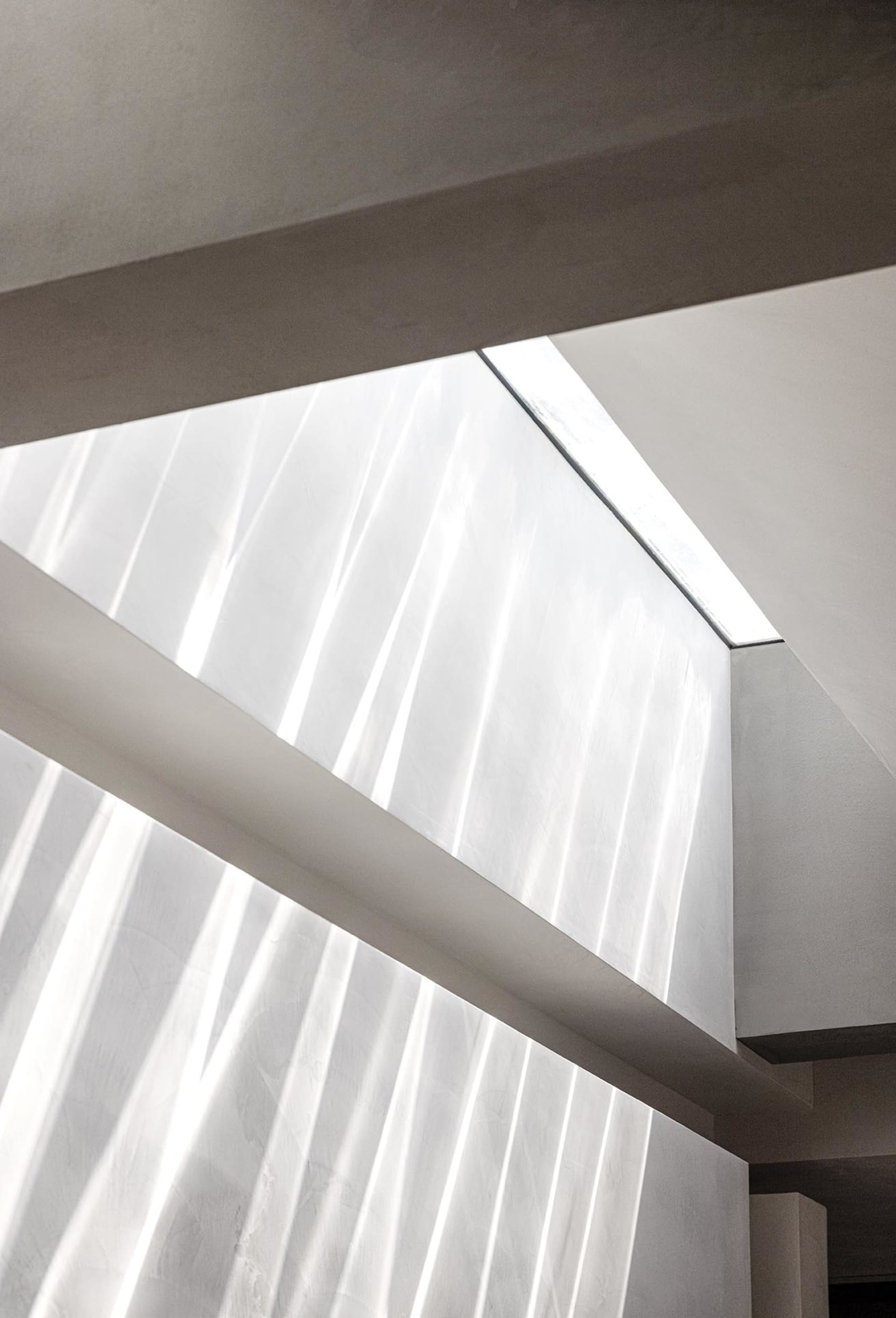 A modern interior design featuring glass and concrete elements.