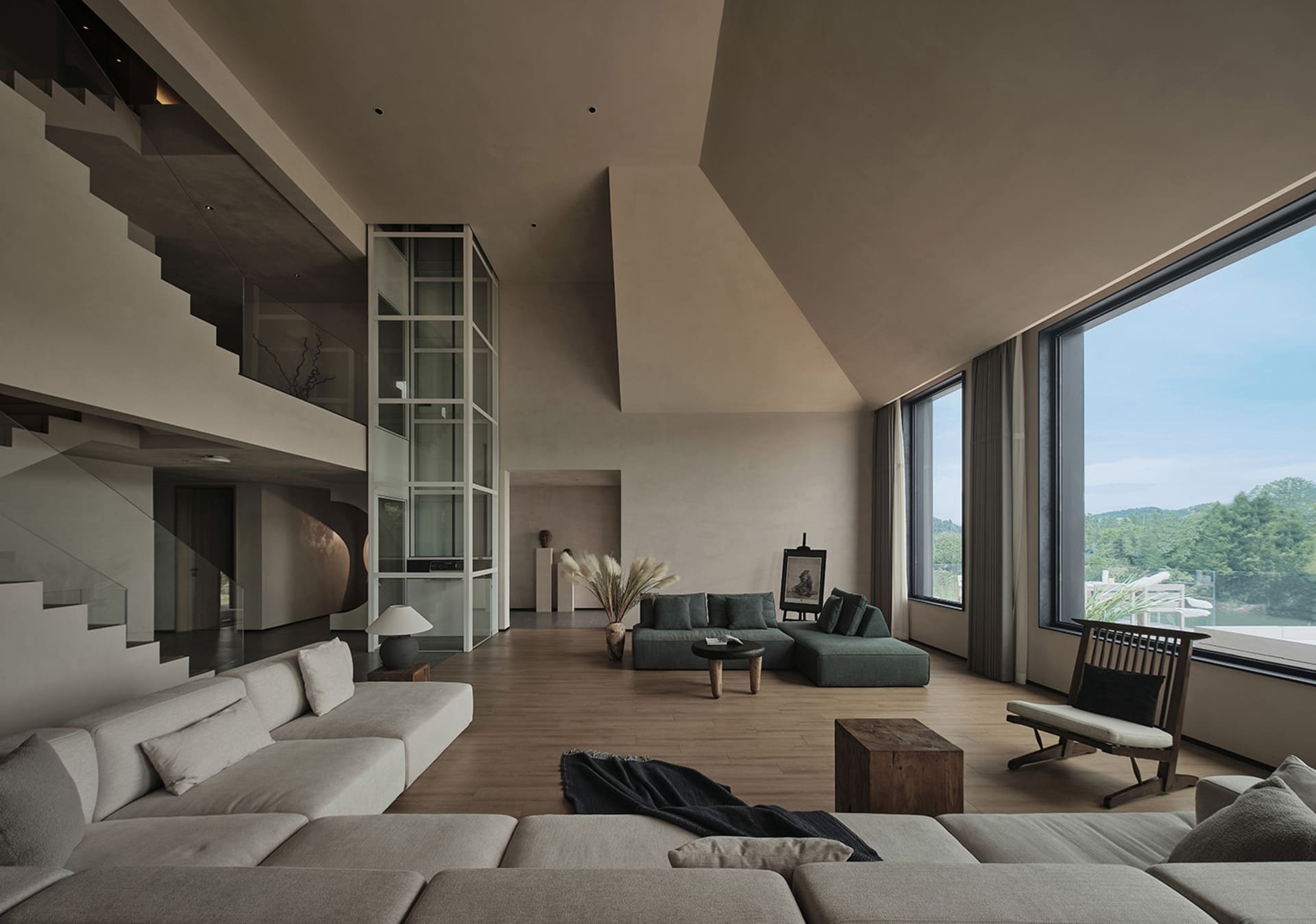 Modern living room featuring concrete and wooden elements, with large windows and a minimalist design.