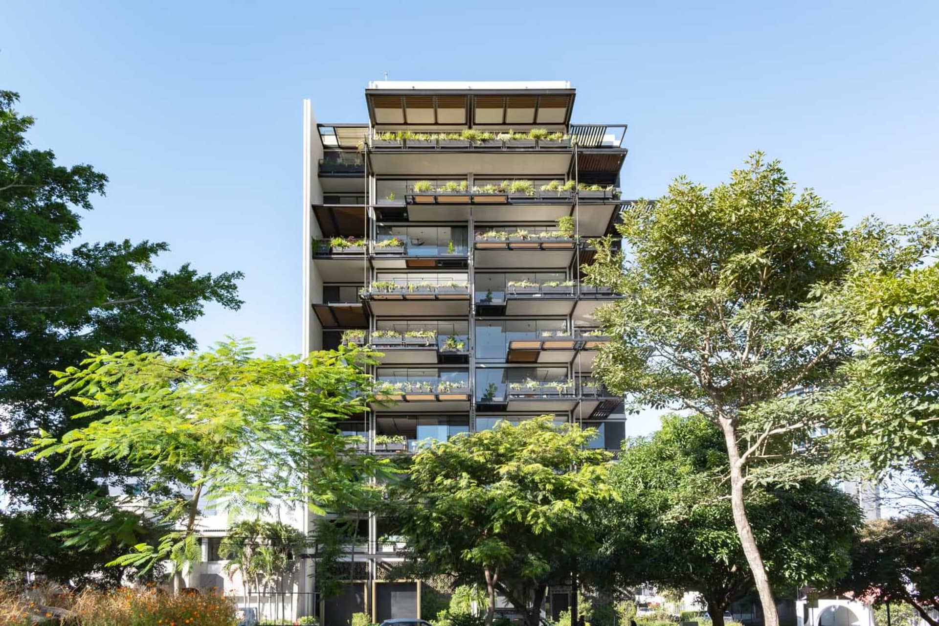 Modern residential building featuring glass and stone materials.
