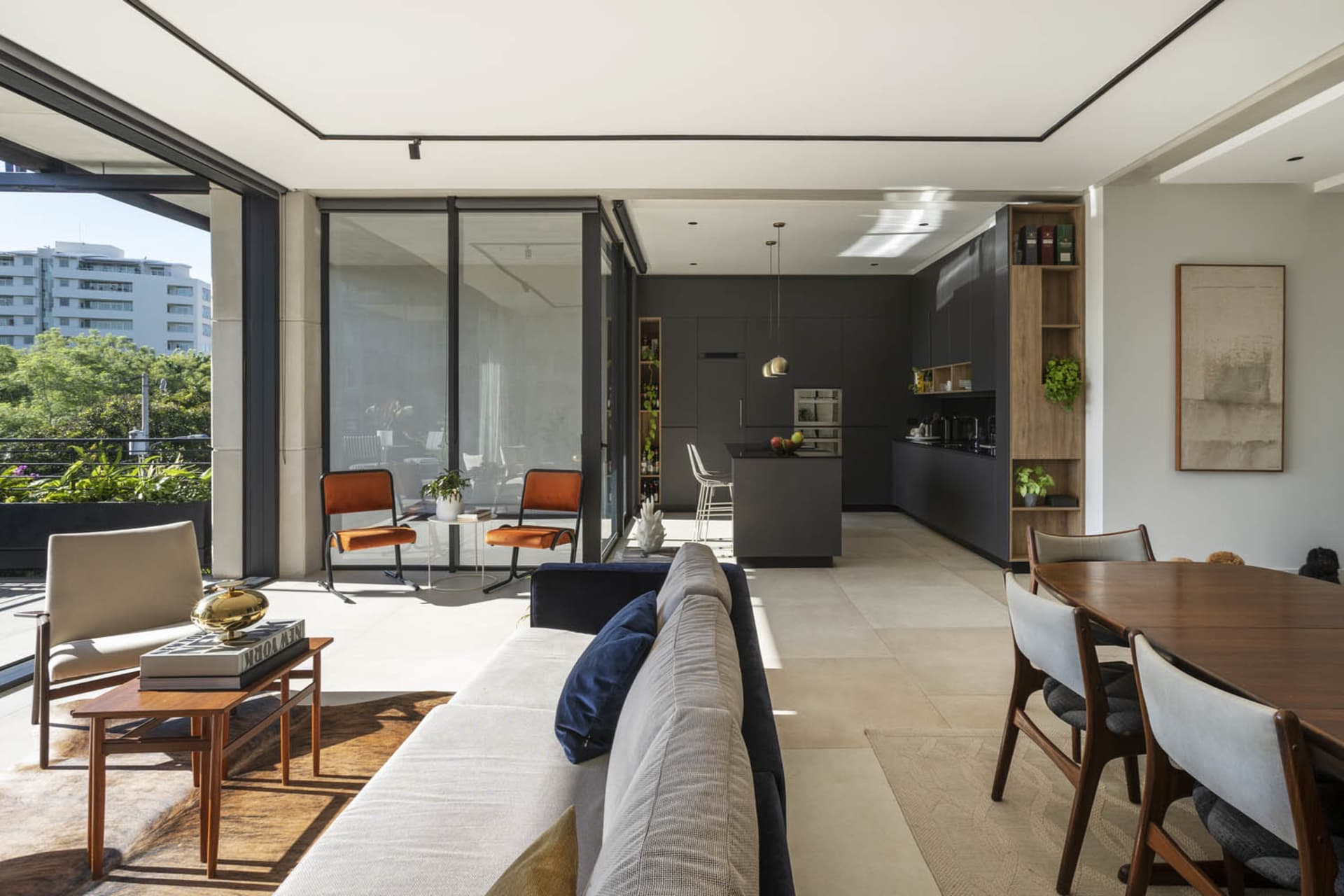 Modern living room with concrete flooring and minimalist furniture.