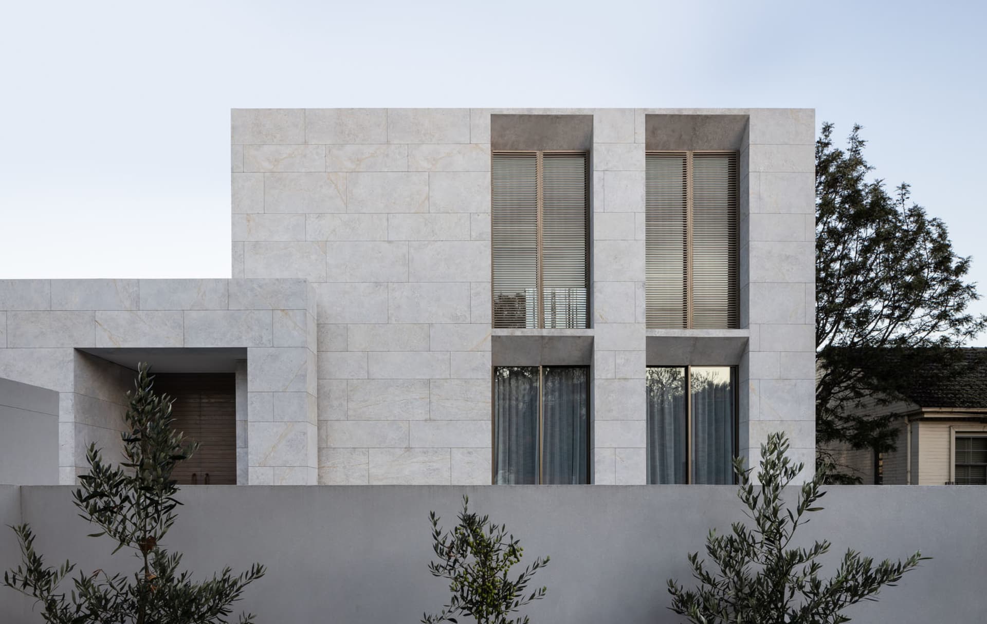 Modern house exterior with white marble finish.