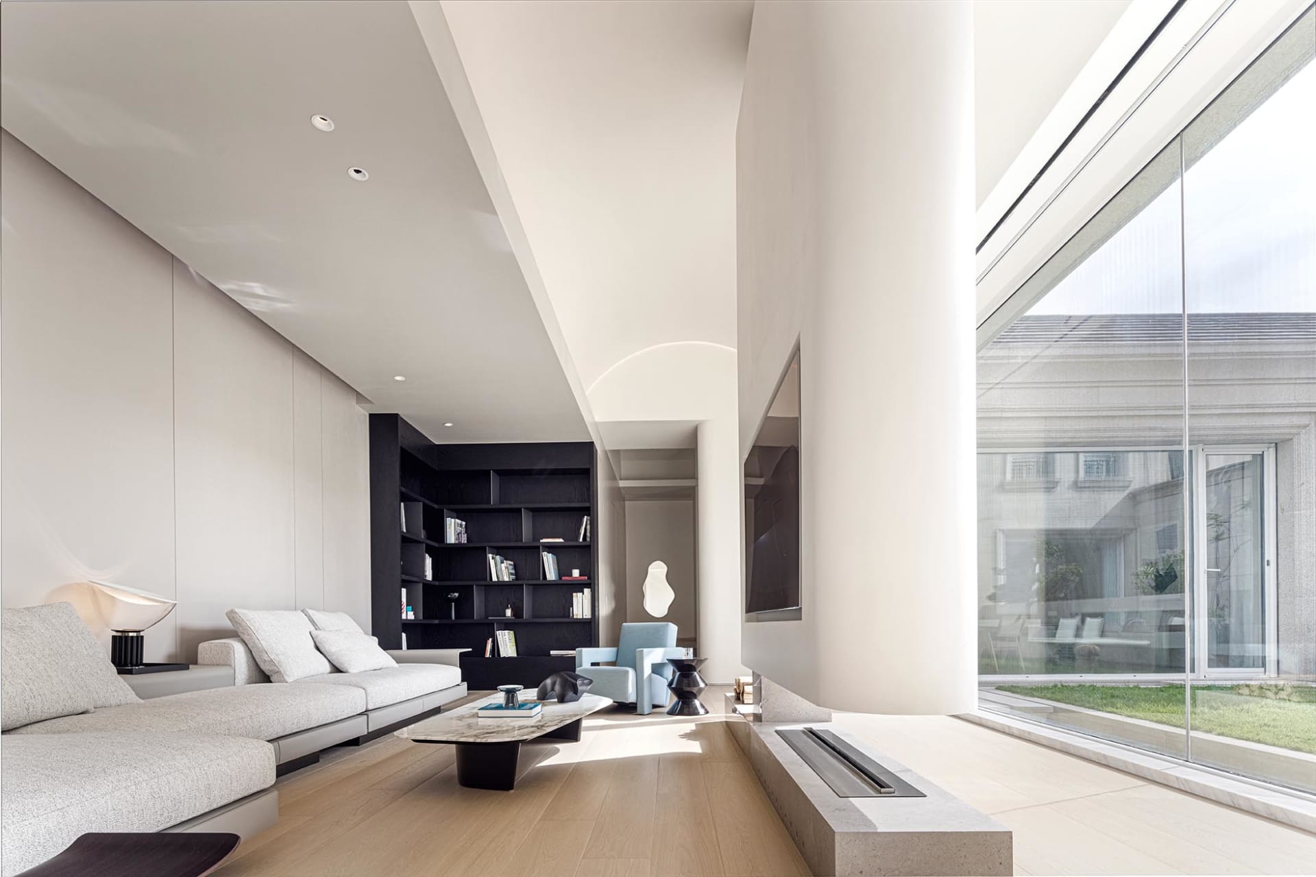 Modern living room featuring concrete, glass, and bamboo materials.