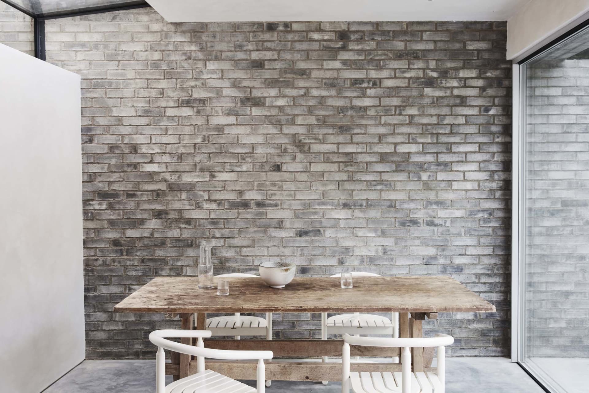 Industrial dining room featuring wooden furniture and concrete walls