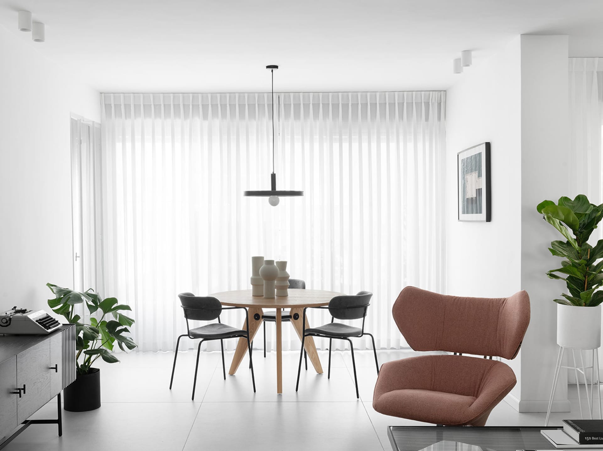 Modern living and dining room featuring furniture made from wood, cotton canvas upholstery, metal accents, and minimalistic d