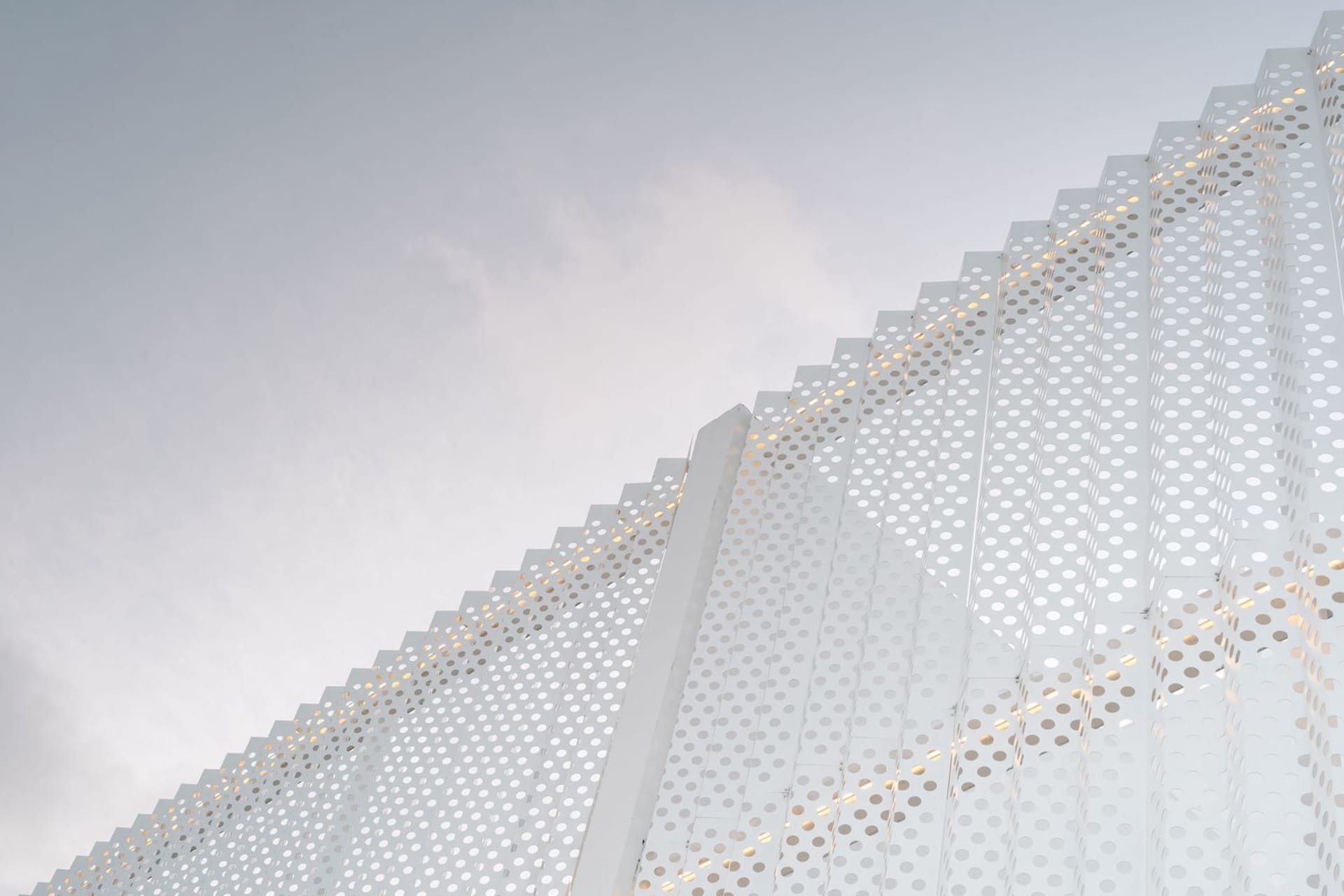 Modern minimalist building with perforated metal facade