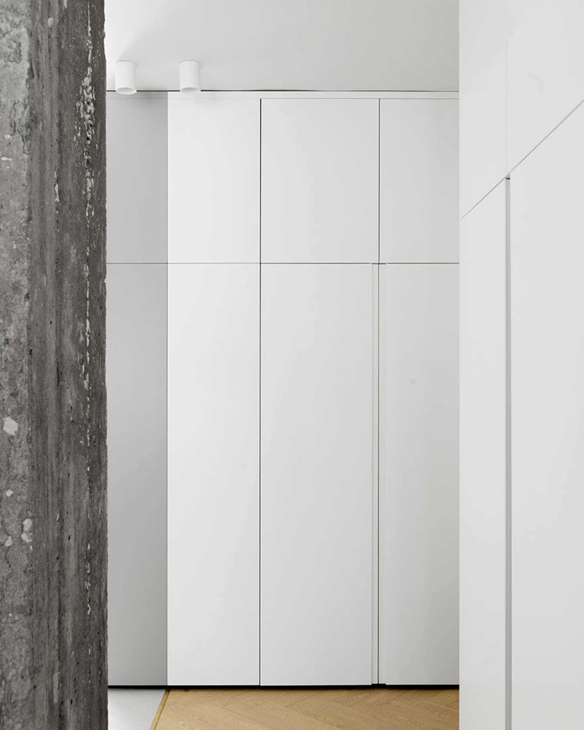 A modern white panel cabinet with clean lines and a minimalist design.
