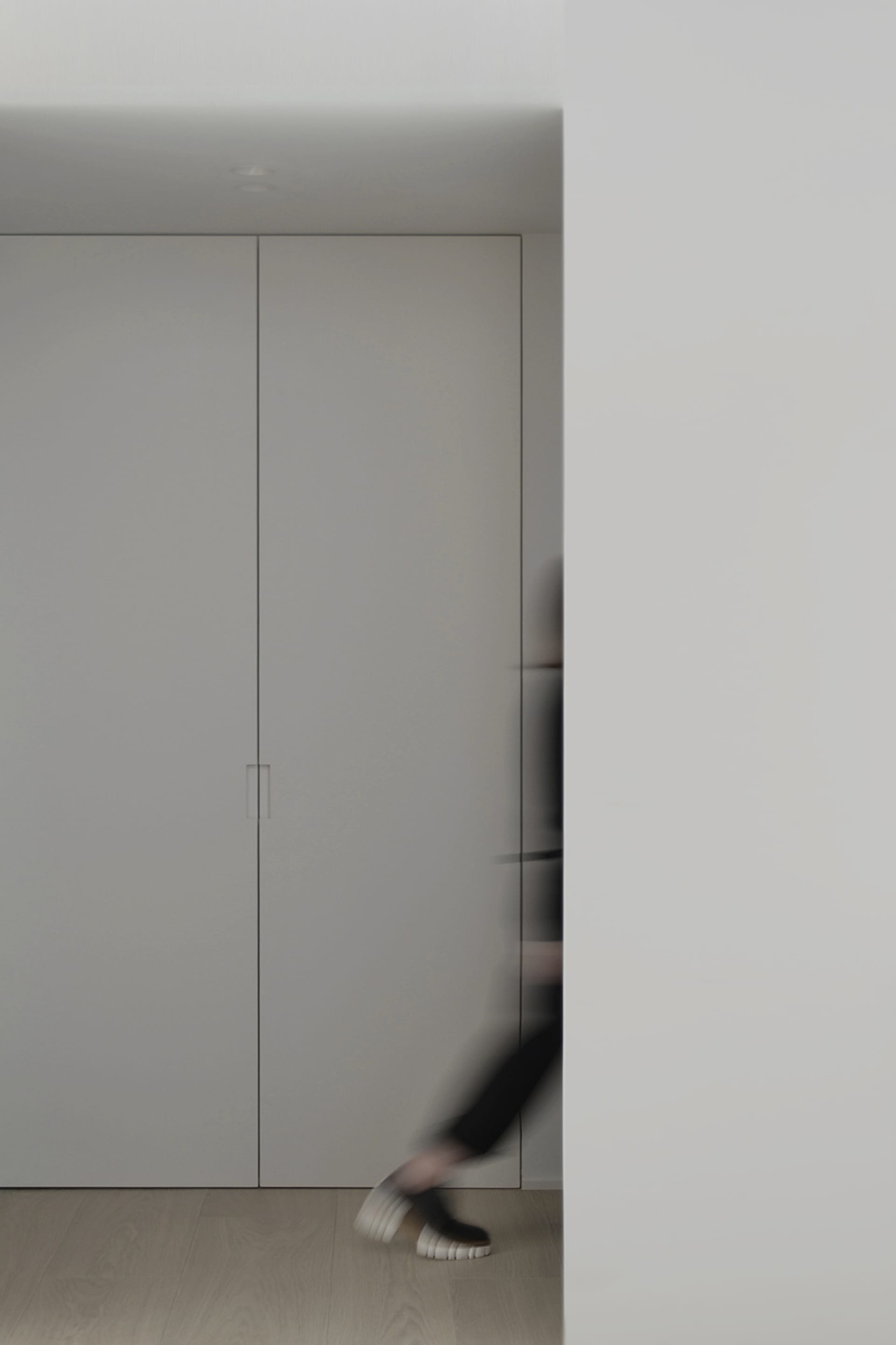 A minimalist interior with white cabinets and a smooth, sleek design.