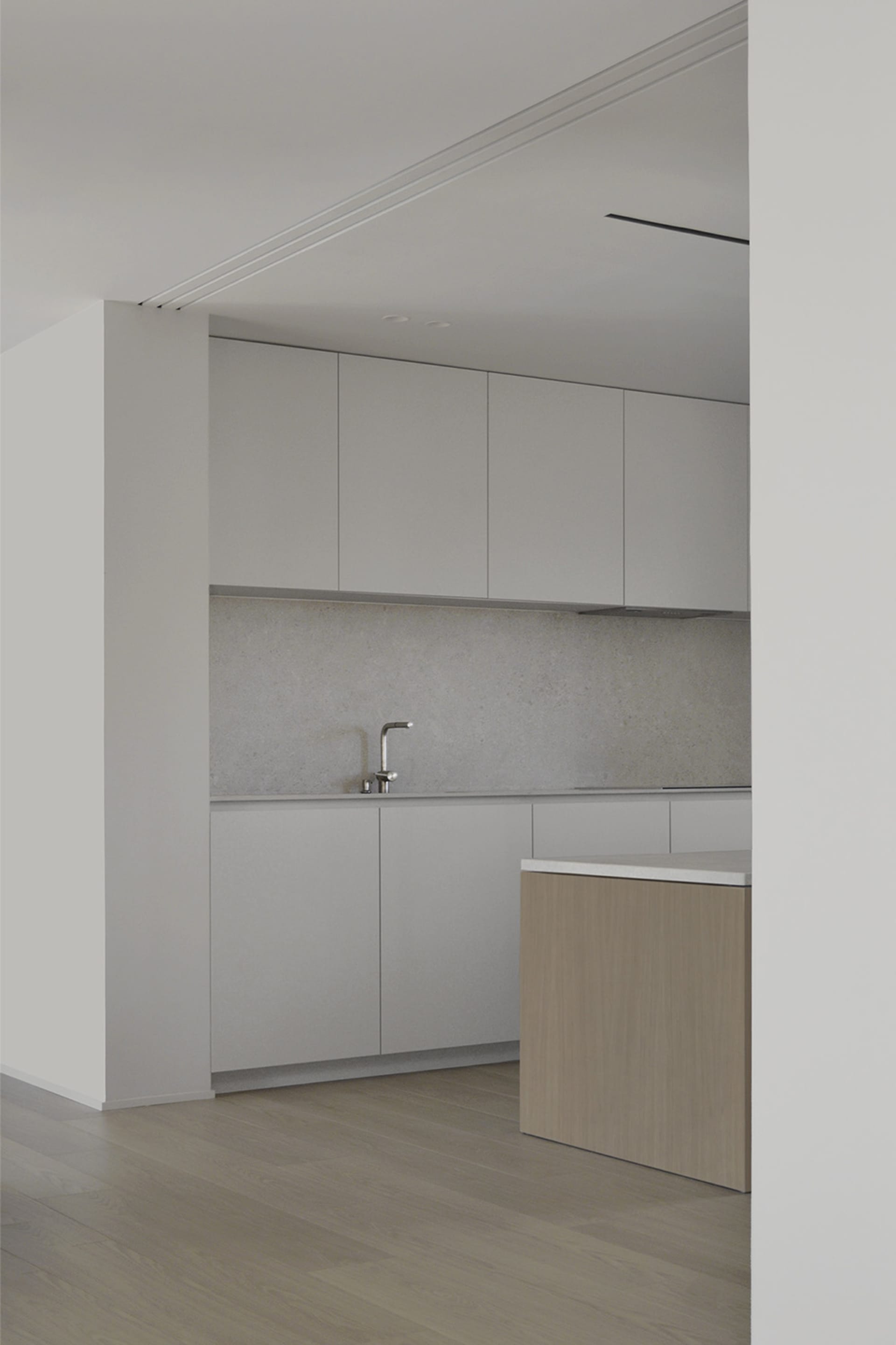 A minimalist kitchen with concrete countertops and cabinets.
