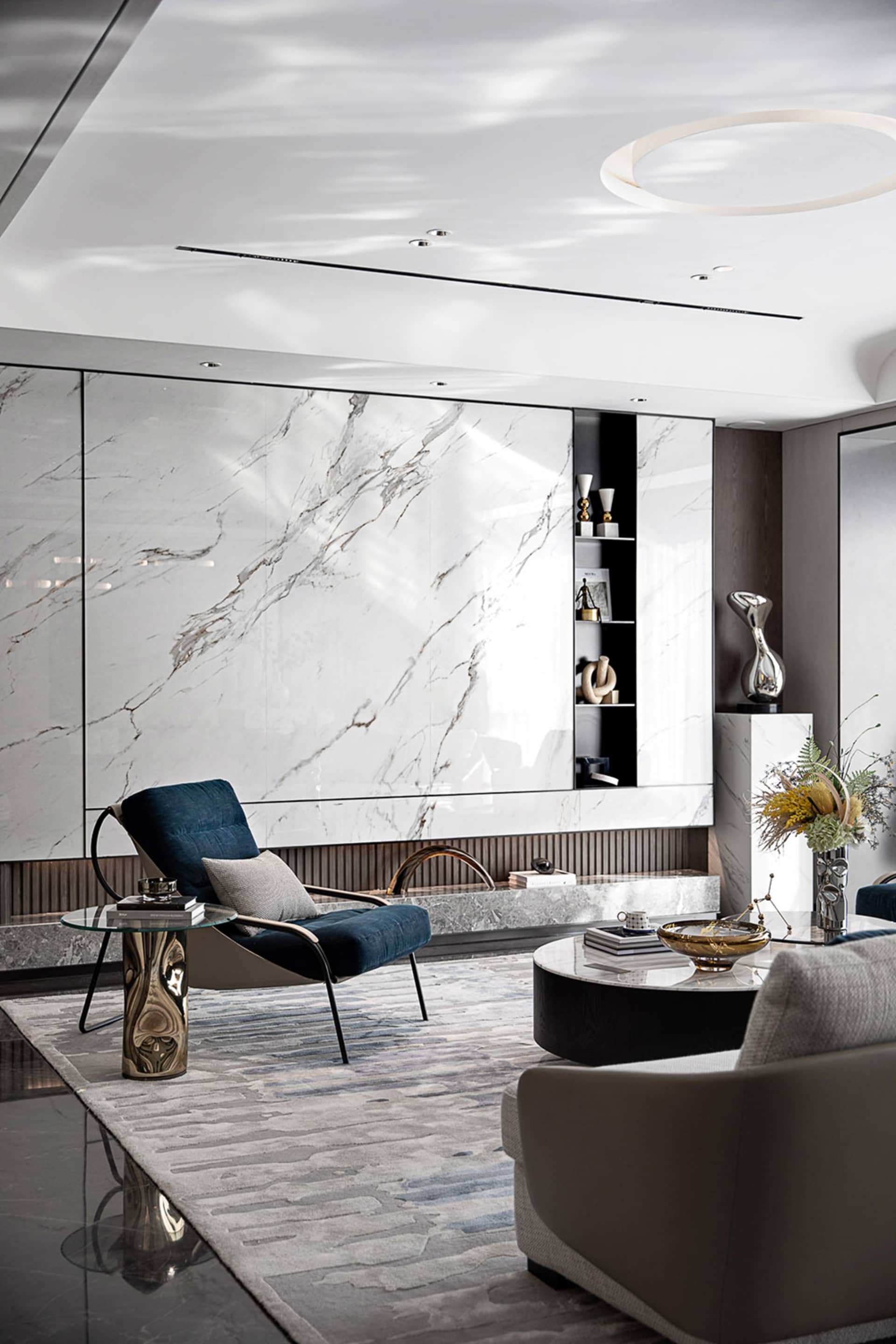 Modern living room featuring marble walls and leather furniture