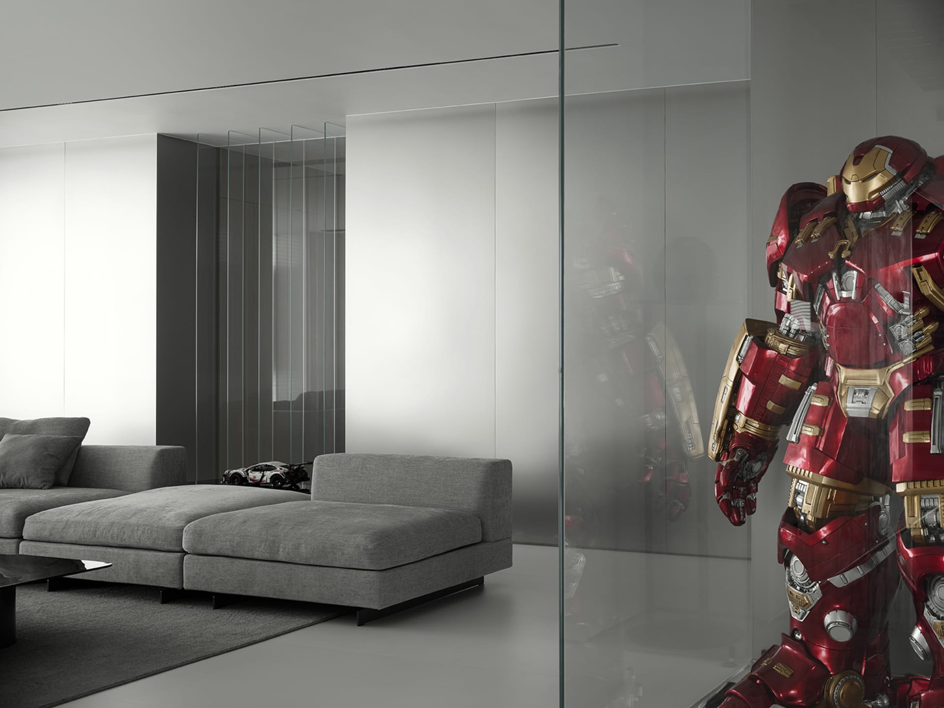Modern living room with a contemporary upholstered sofa and a red armored figure.