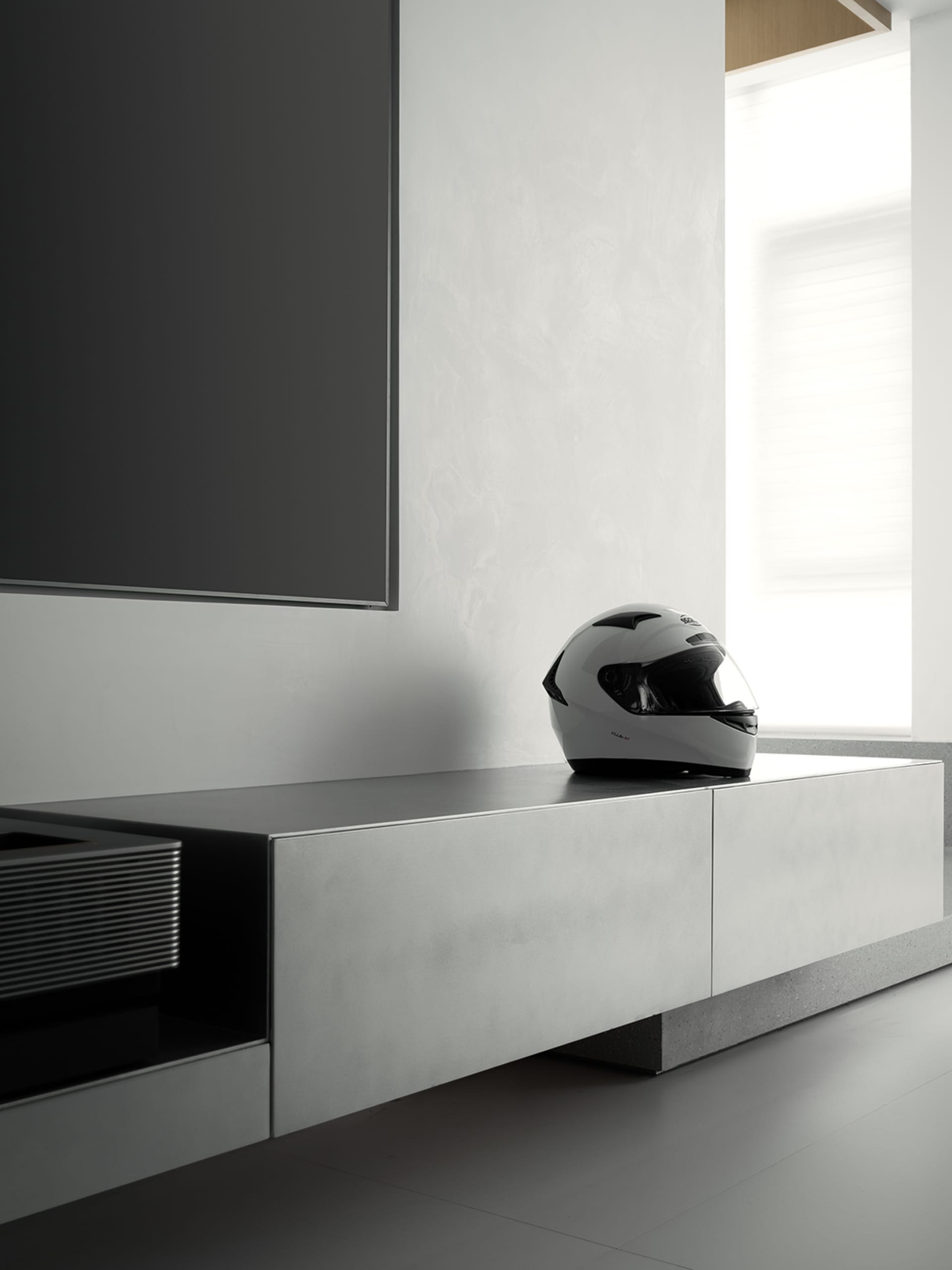 A sleek, minimalist living room with a concrete finish.