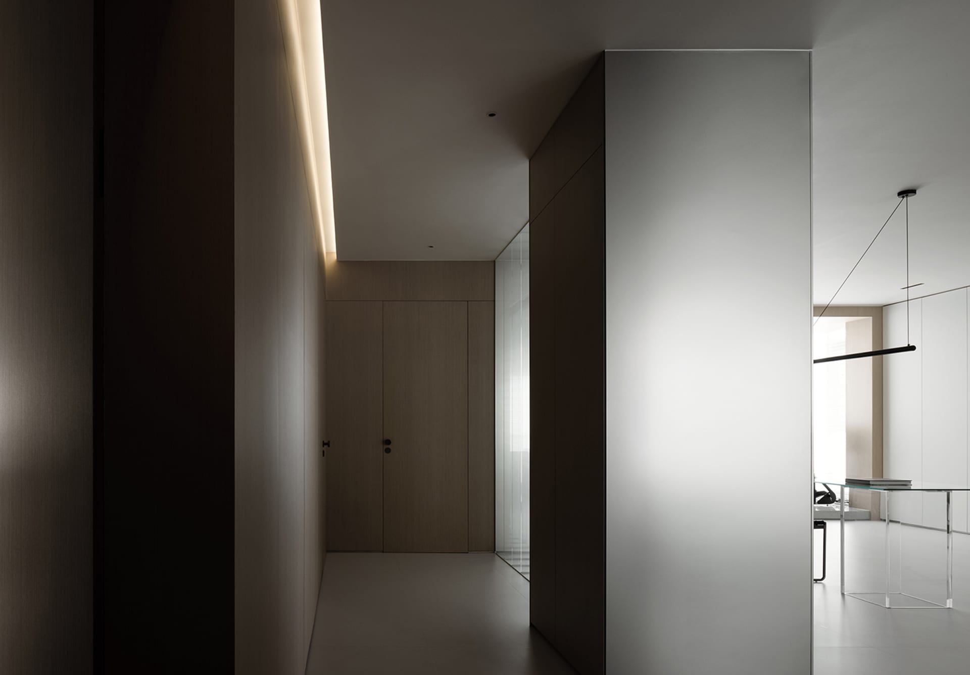An elegant modern office with glass walls and concrete flooring.