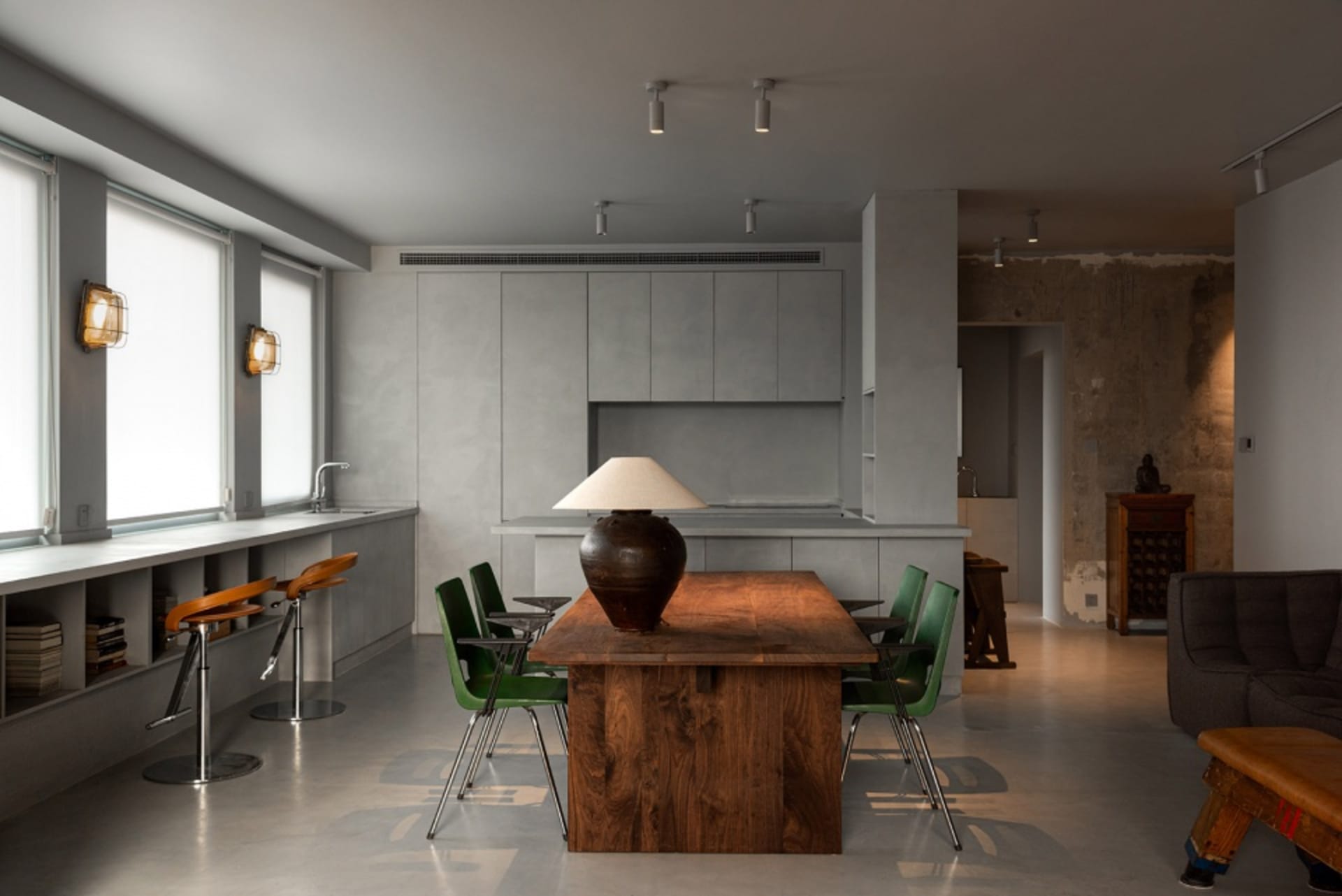 An industrial-style residential kitchen with a concrete and wooden theme.