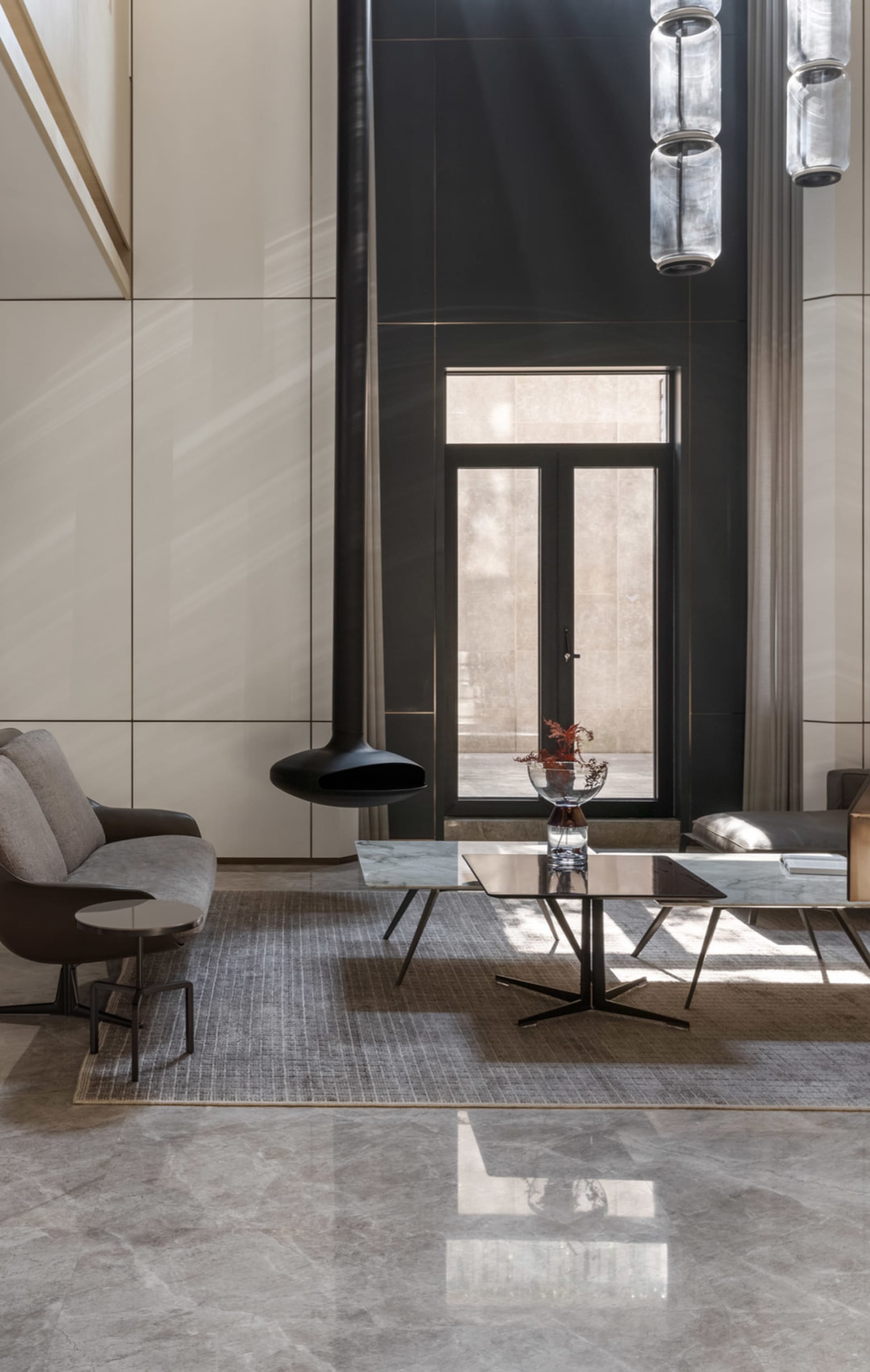 Modern minimalist living room featuring marble and glass elements.