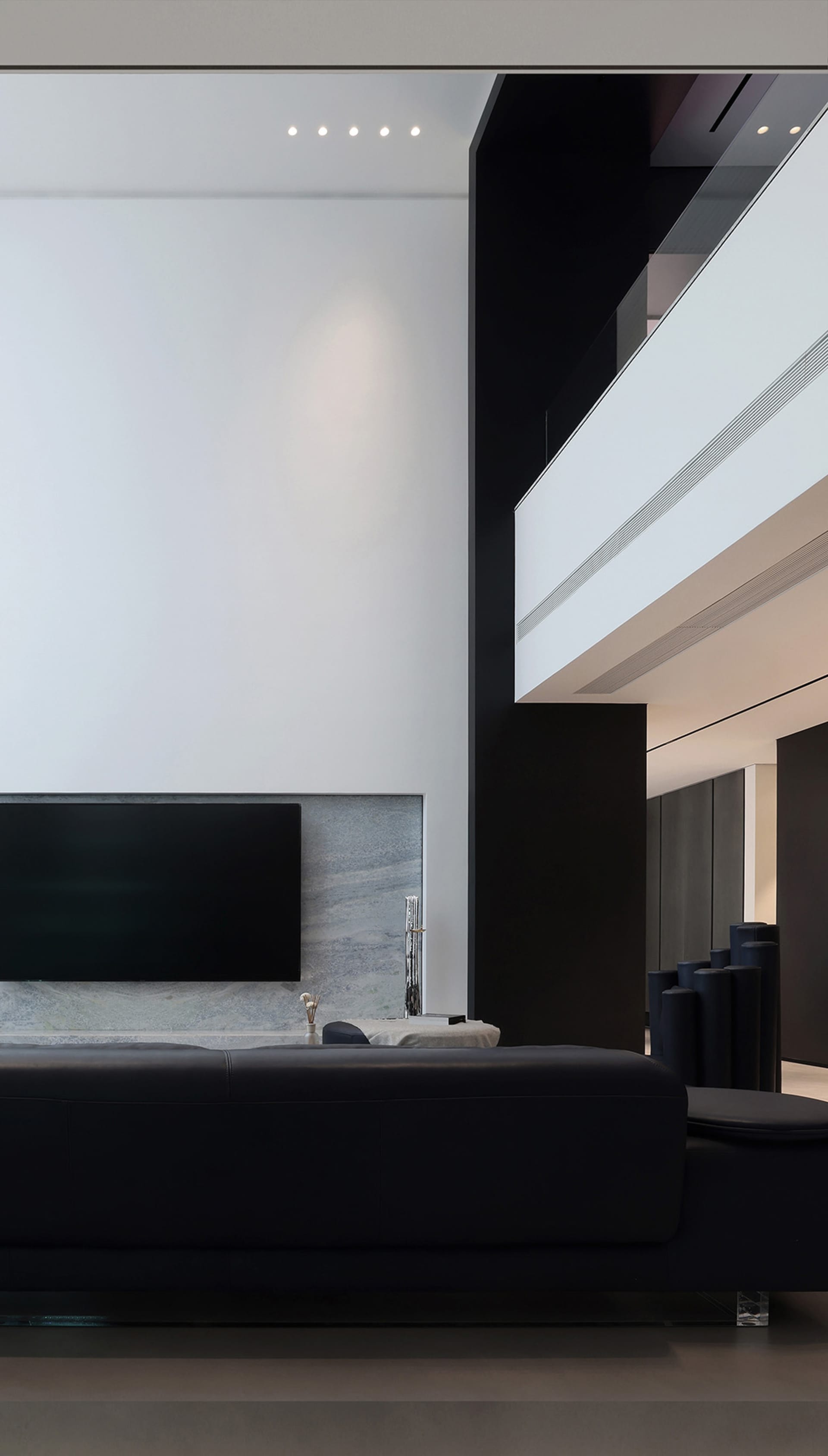 Modern minimalist living room featuring concrete and steel materials.