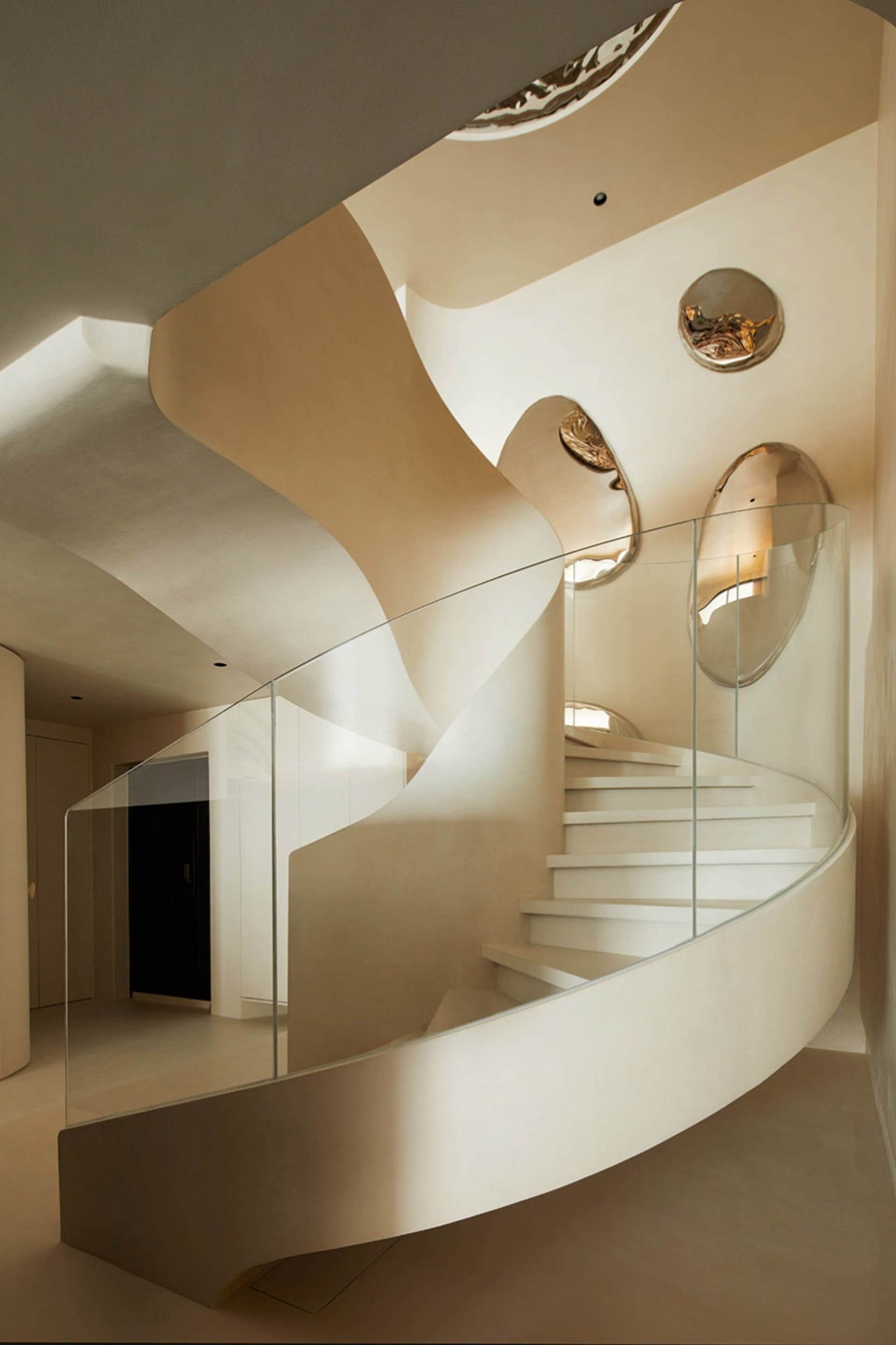 Modern staircase featuring glass railings and concrete steps