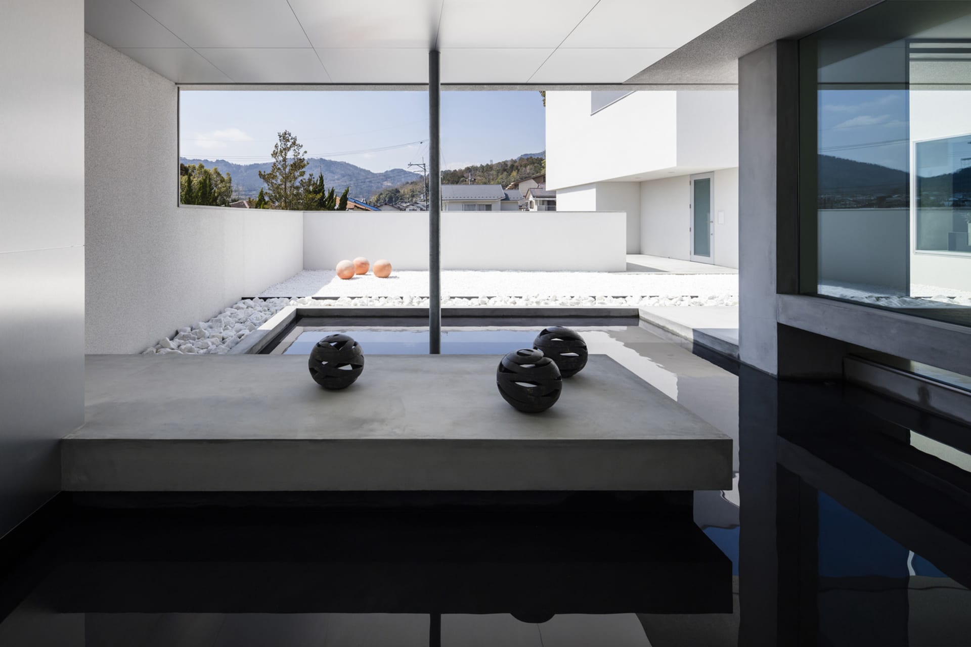 Modern, minimalist design featuring concrete elements in an outdoor setting.