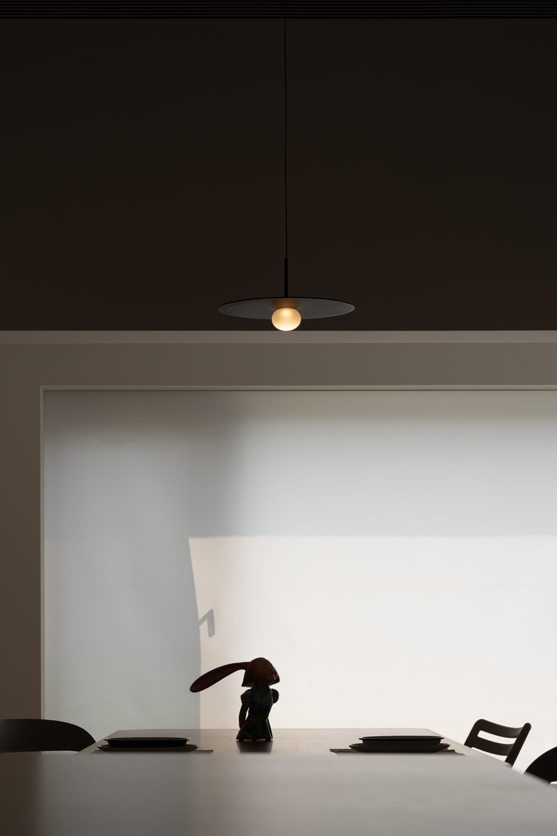 A modern interior space featuring minimalist design and contemporary lighting fixtures.