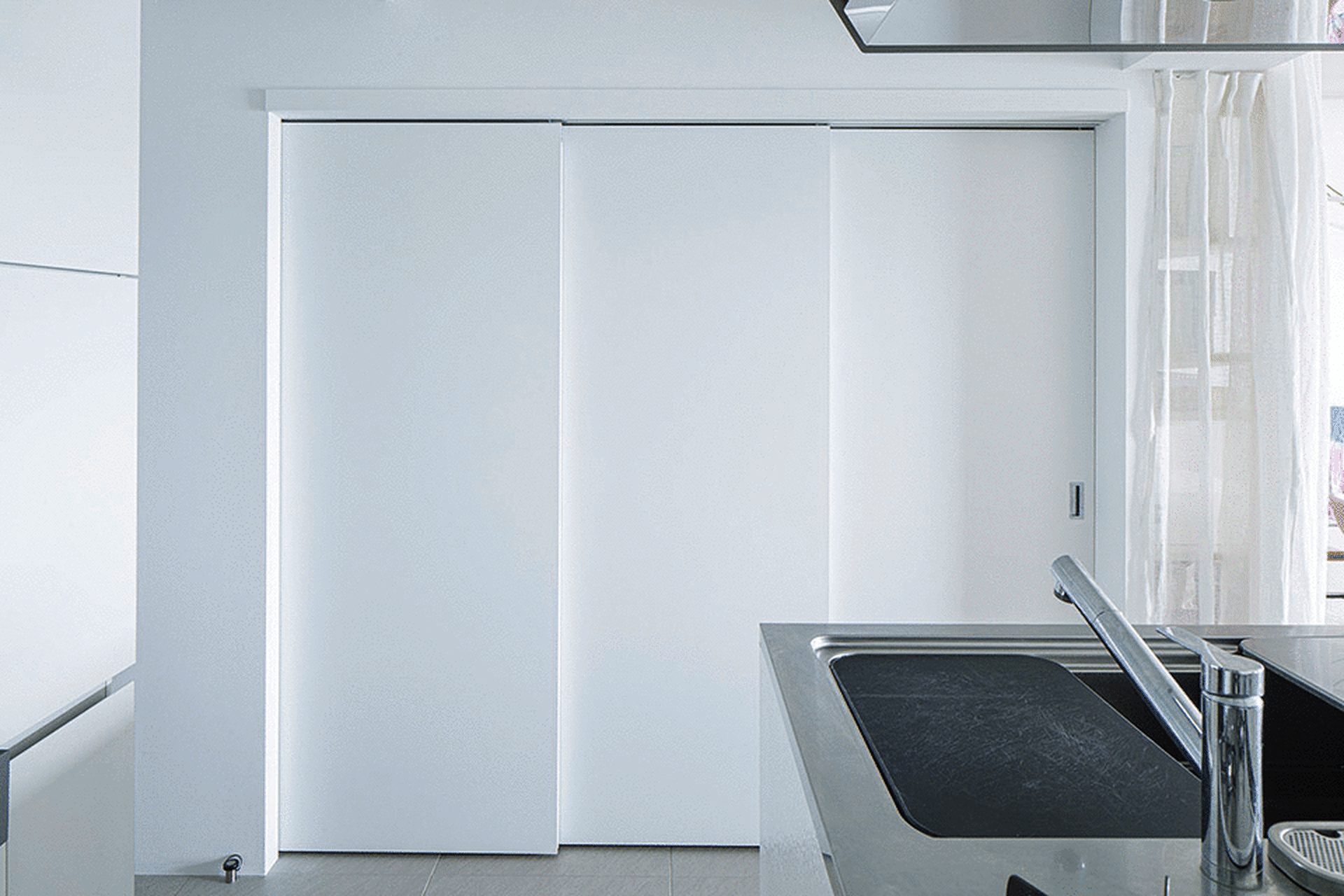 Modern kitchen with white cabinets and a sleek, minimalist design.