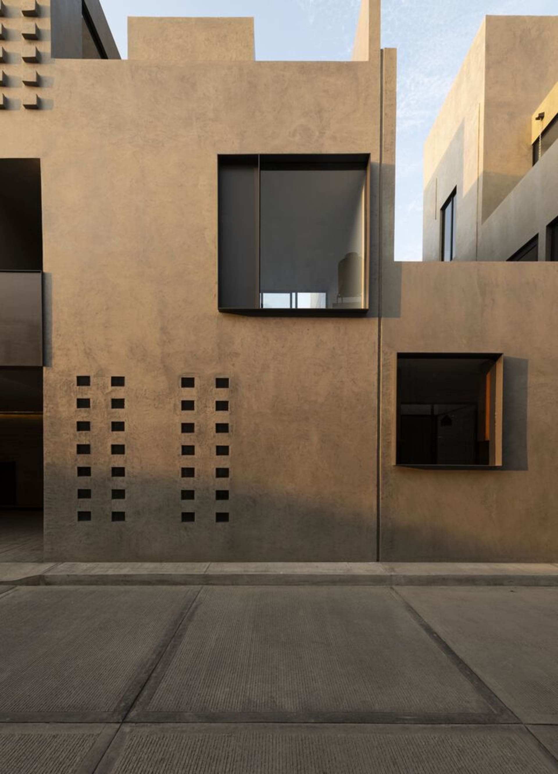 An exterior view of a modern building featuring reclaimed concrete materials.