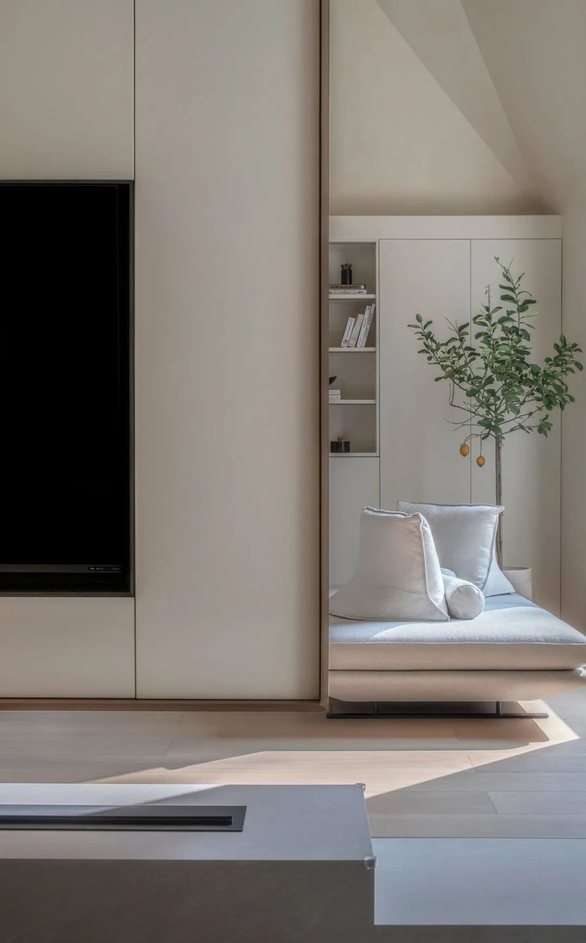 A minimalist living room with a sofa and a bookshelf