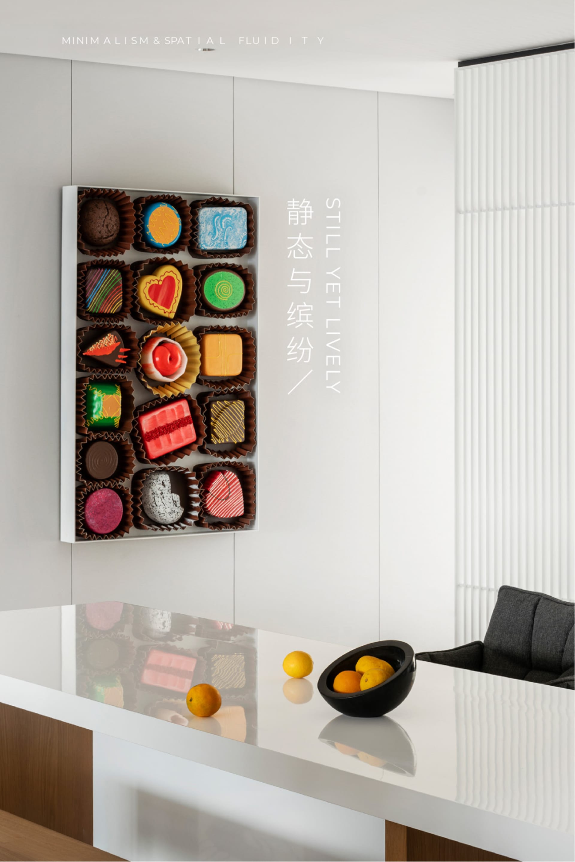 A well-designed minimalist interior featuring a sleek black table with oranges, a white counter with a black bowl of oranges,