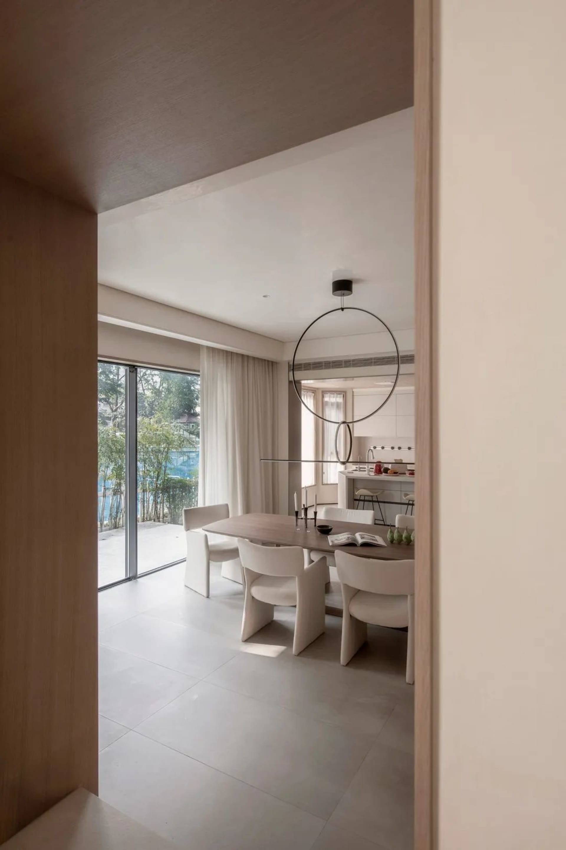 Contemporary living room with minimalist design, featuring wood and glass furniture and fixtures.