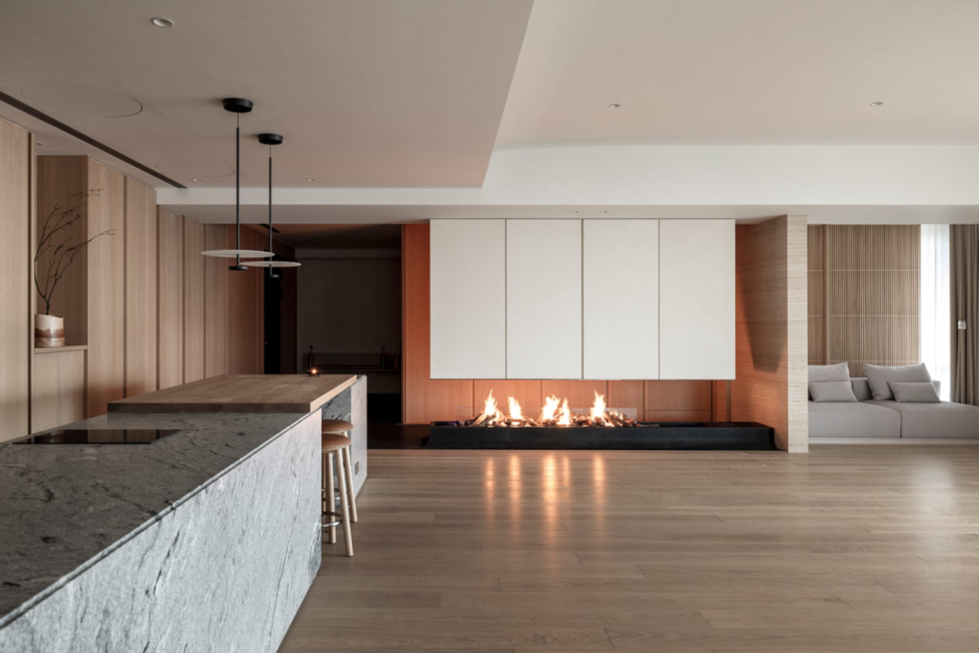 A modern living room featuring wooden flooring and minimalist furniture.
