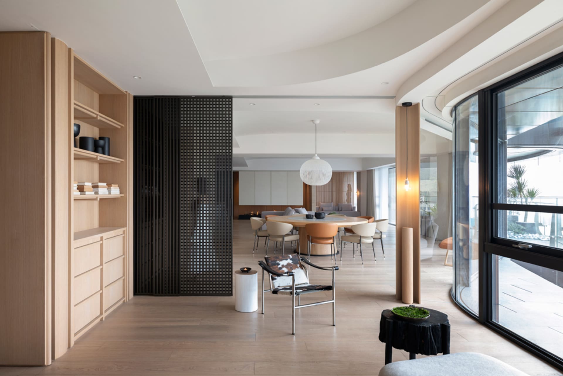 Contemporary residential living room featuring wood and glass materials.