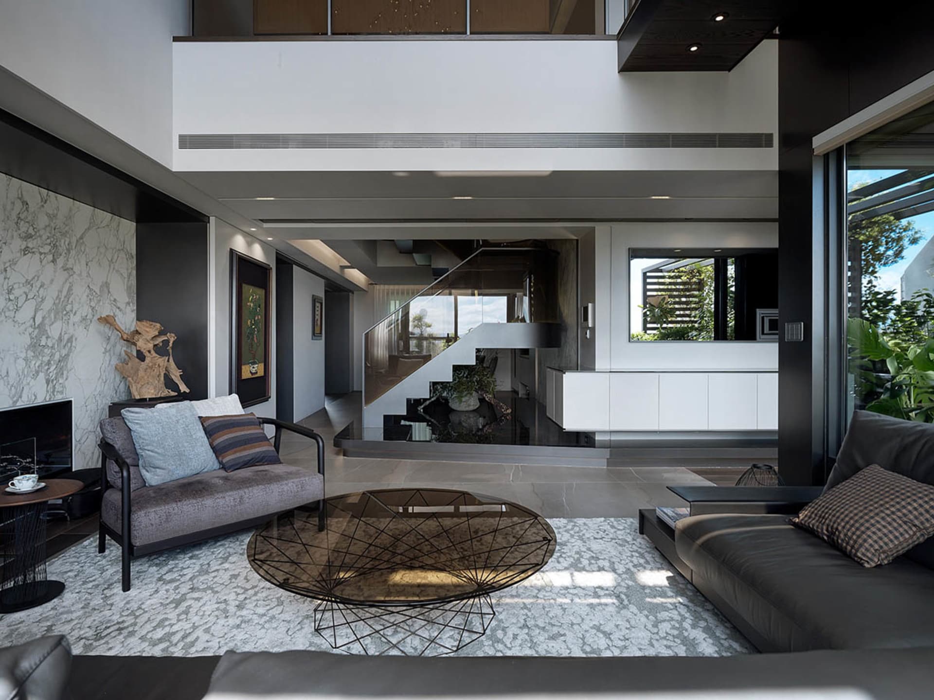 Modern living room featuring a metal, leather, and marble design