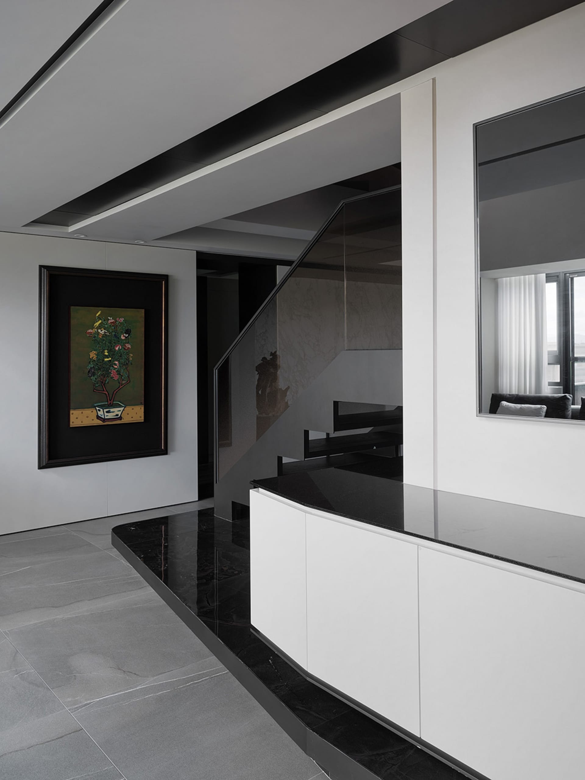 A modern interior design featuring concrete and glass materials.