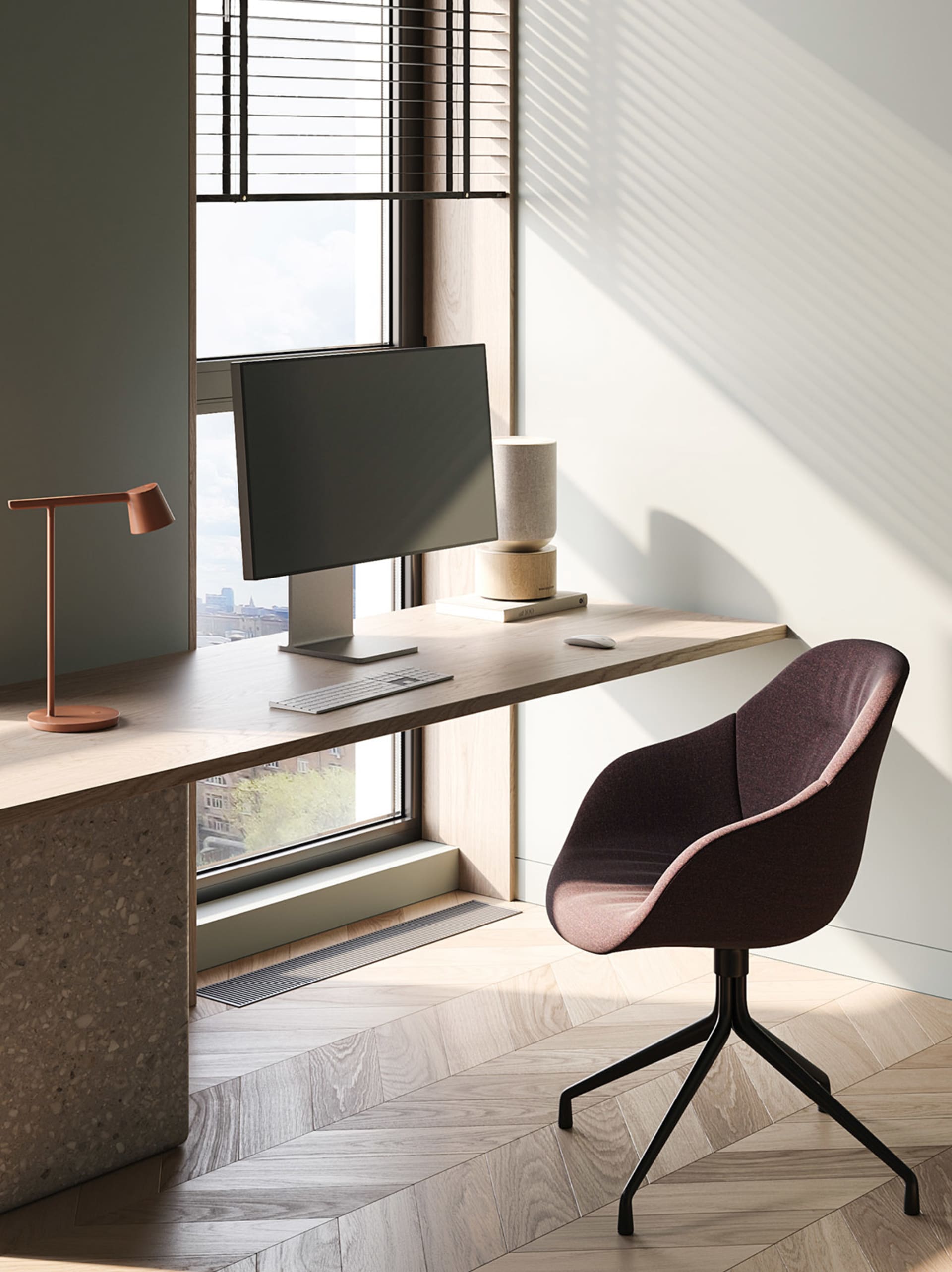 A minimalist home office featuring a wooden desk with a computer setup, a comfortable chair, and a sleek lamp.