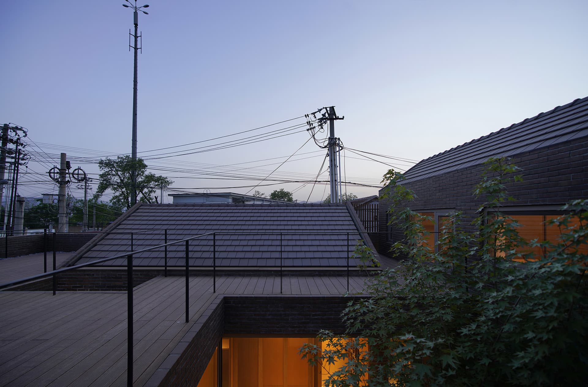 A modern residential building with a brick roof.