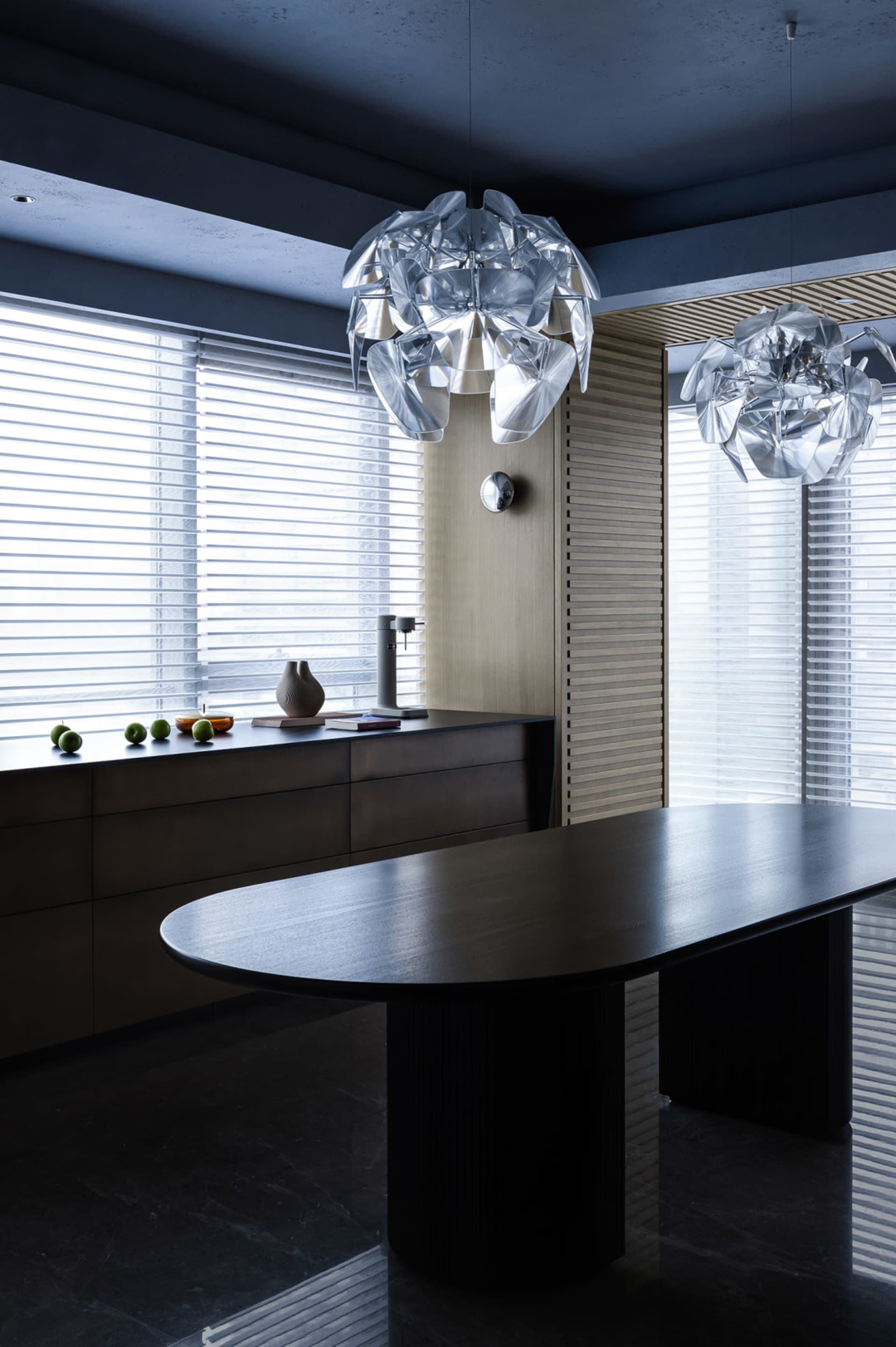 A modern residential interior featuring glass, wood, and metal materials.