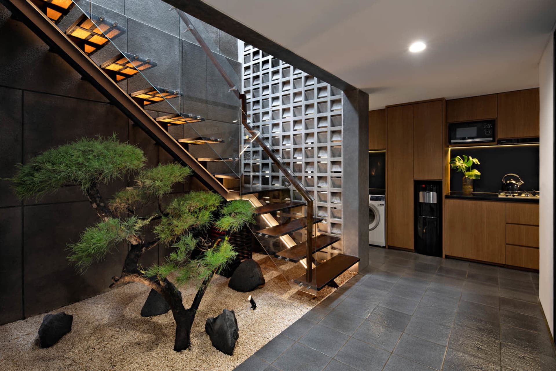 Modern interior design featuring metal, concrete, and glass materials