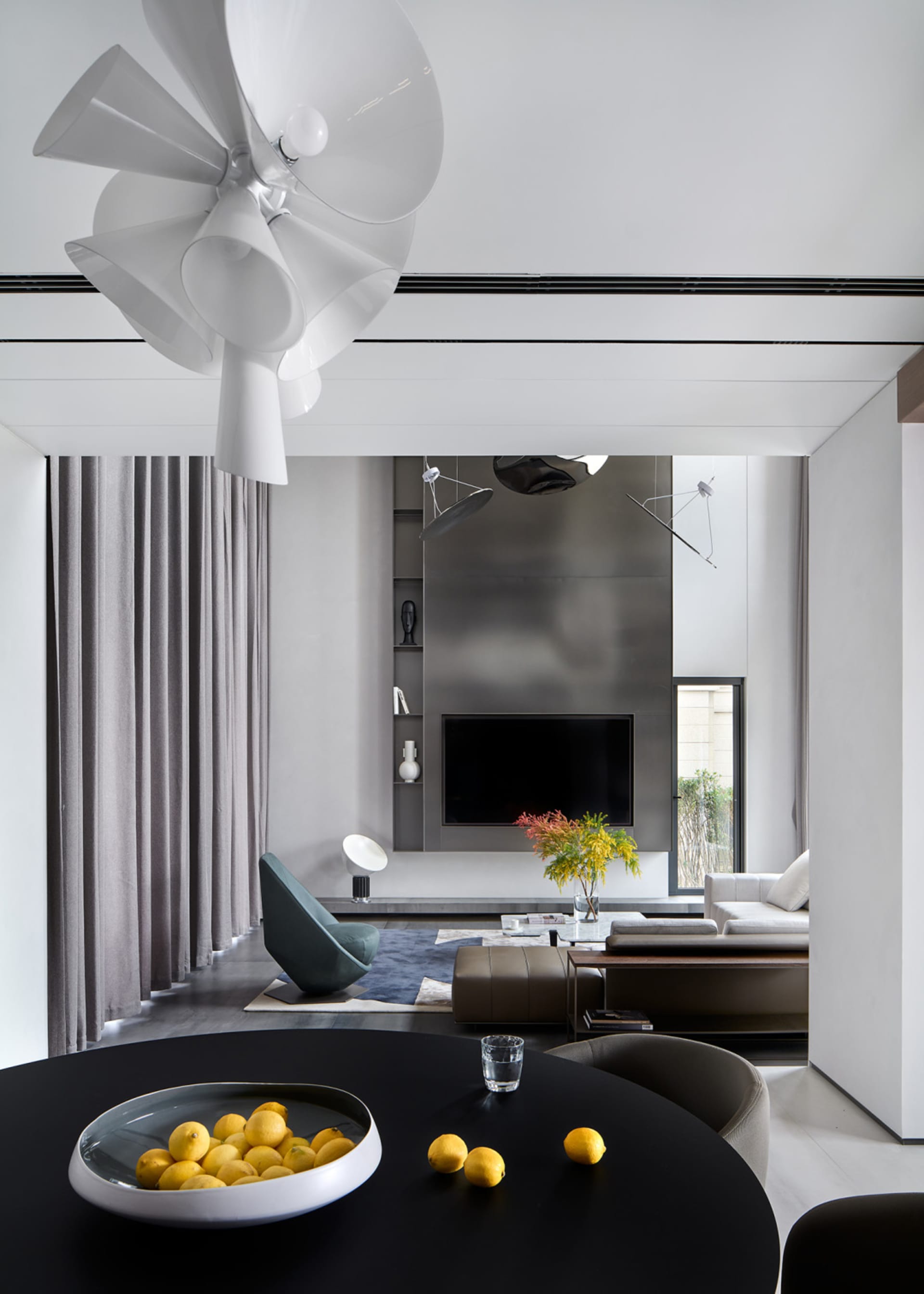 Modern minimalist living room with black and white color scheme and contemporary furniture.