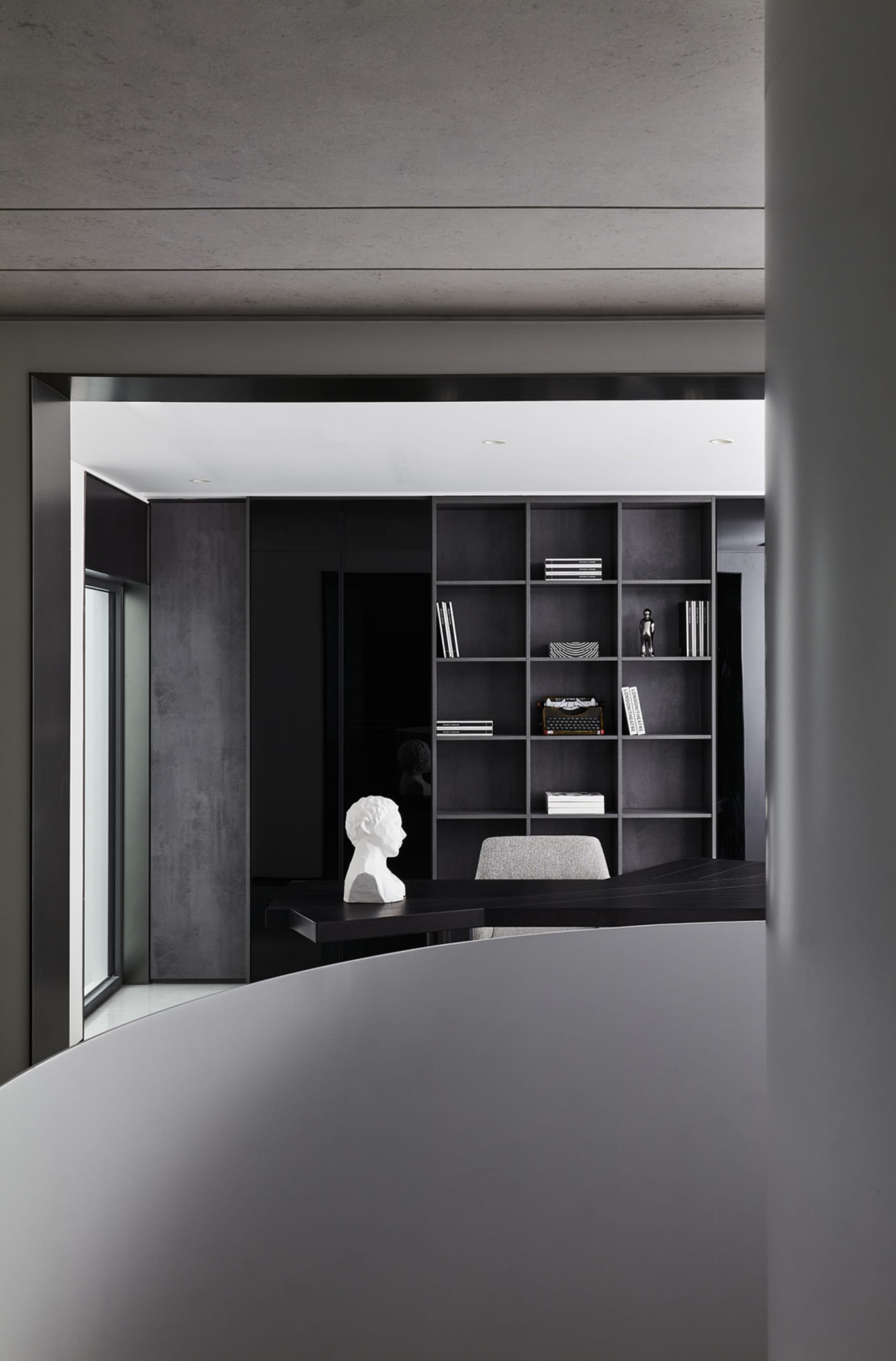 Modern office space with concrete, glass, and metal finishes.