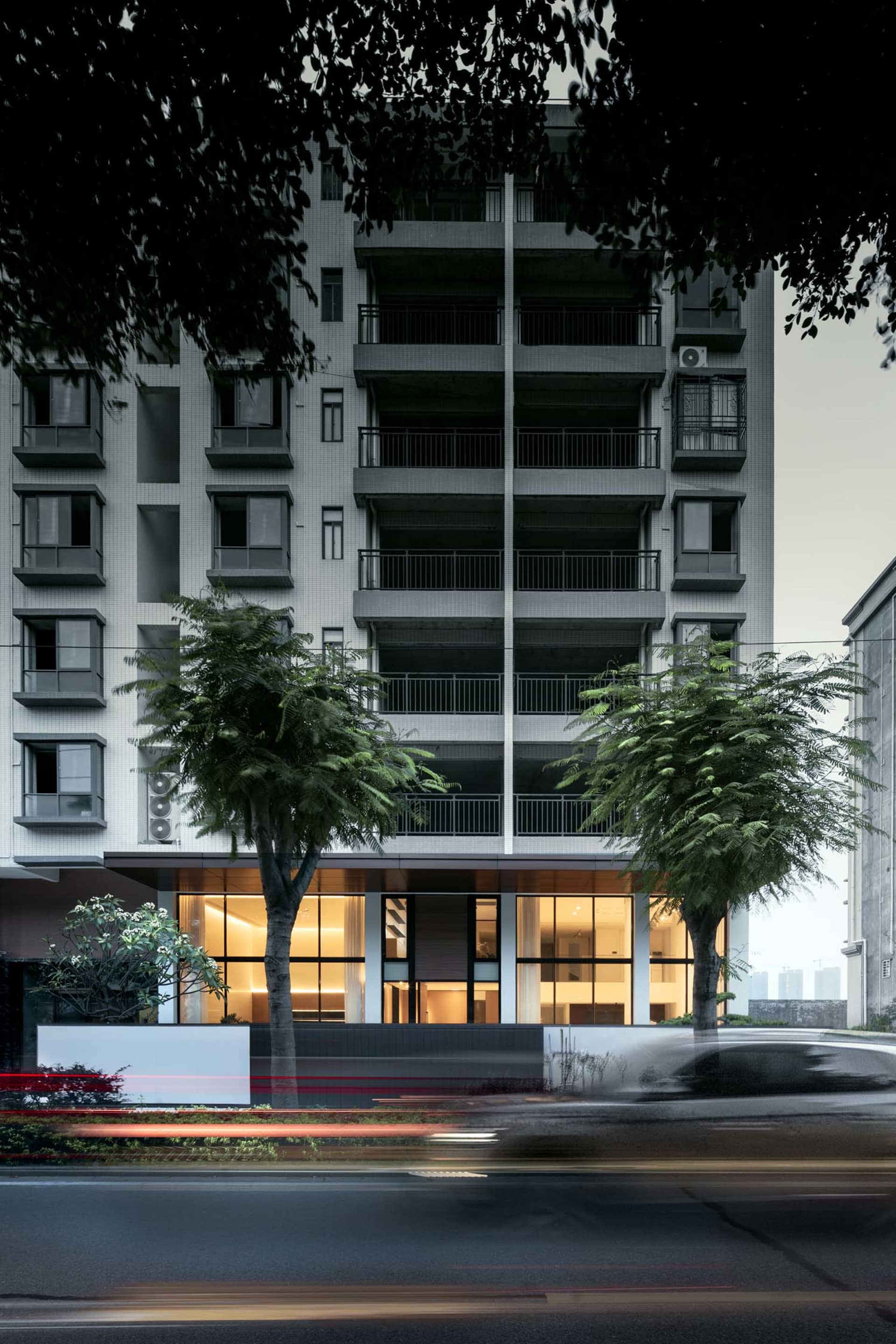 Modern residential building with concrete, glass, and metal materials.