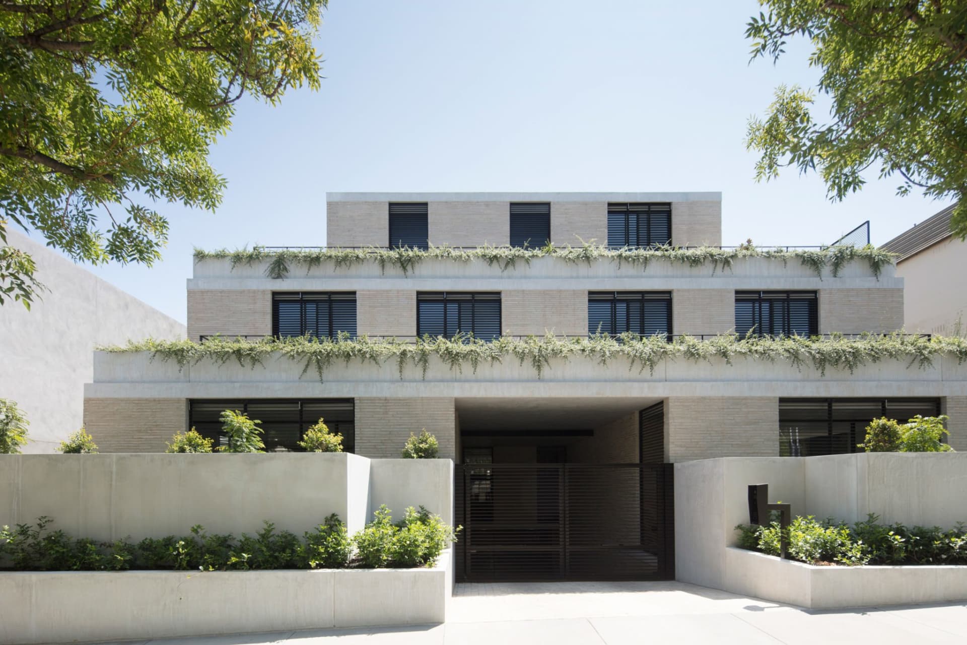 Modern residential building with brick and concrete exterior.
