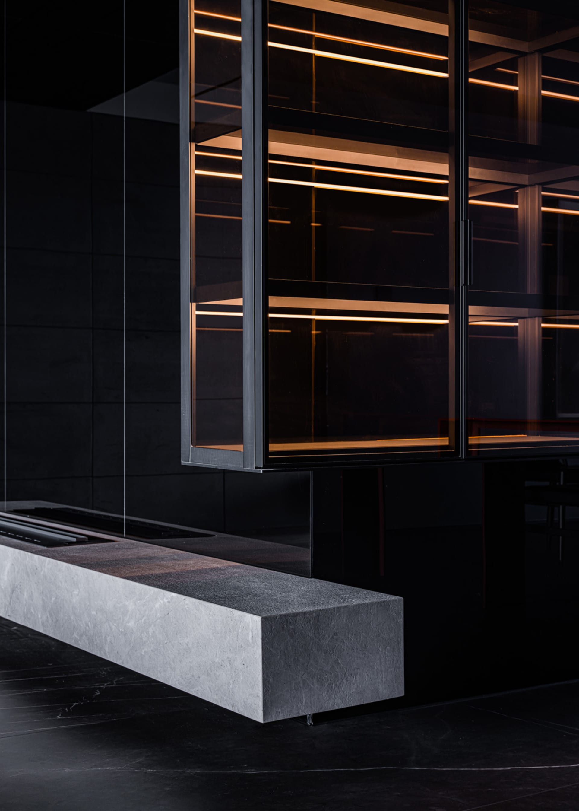 A modern industrial kitchen featuring concrete walls and a minimalist design with sleek, clean lines.