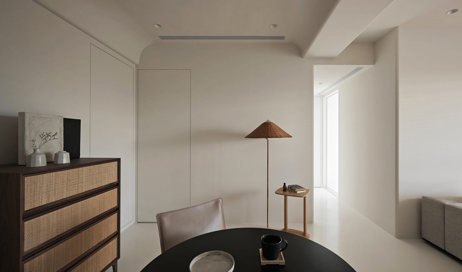 A minimalist living room with neutral-toned materials and a modern design.