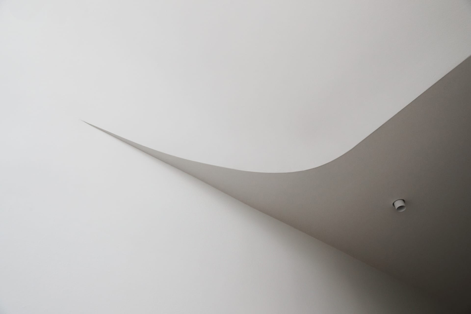 A minimalist architectural design featuring a concrete line.