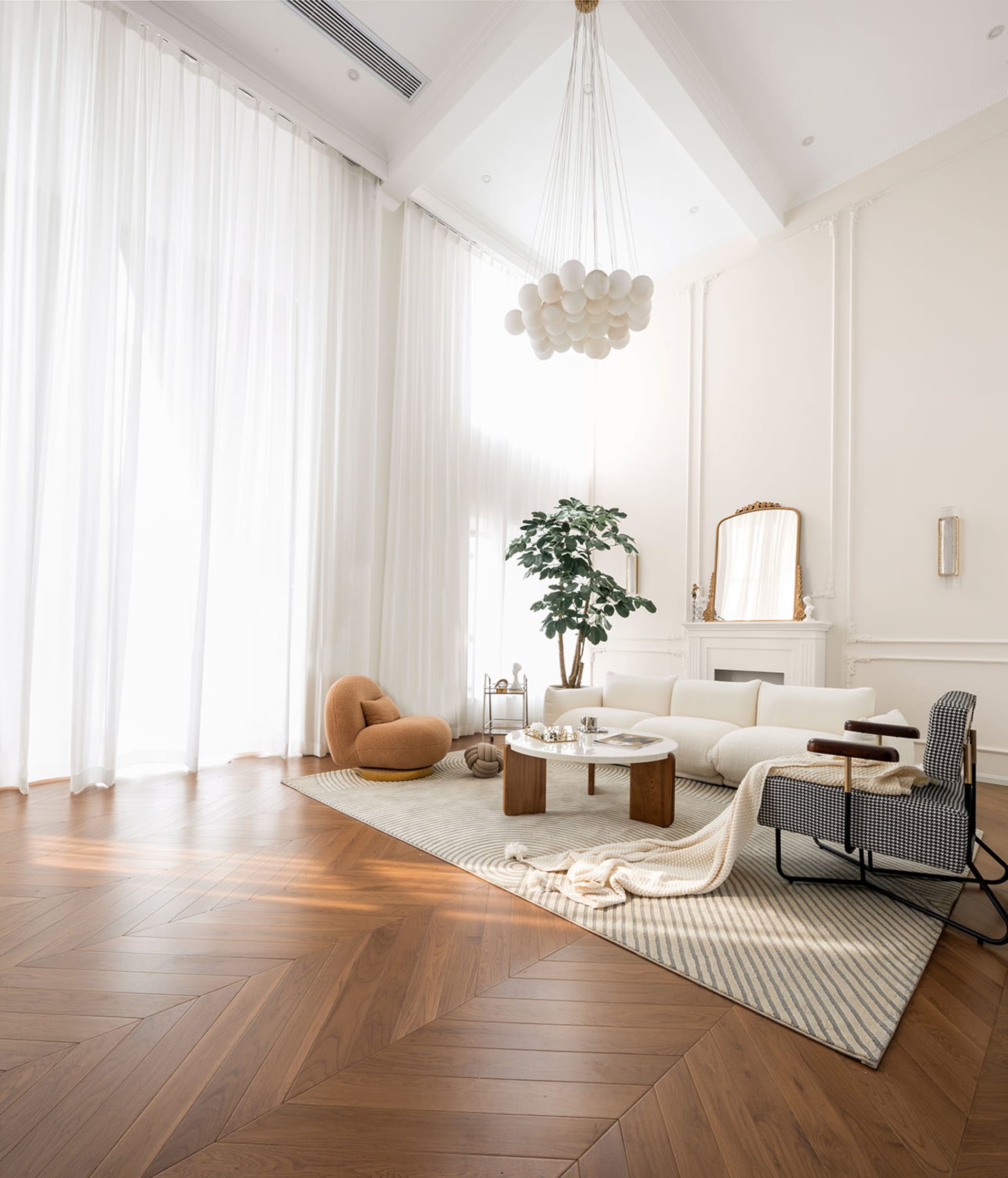 Modern living room featuring a wooden floor with large windows, minimalist furniture, and a cozy atmosphere.
