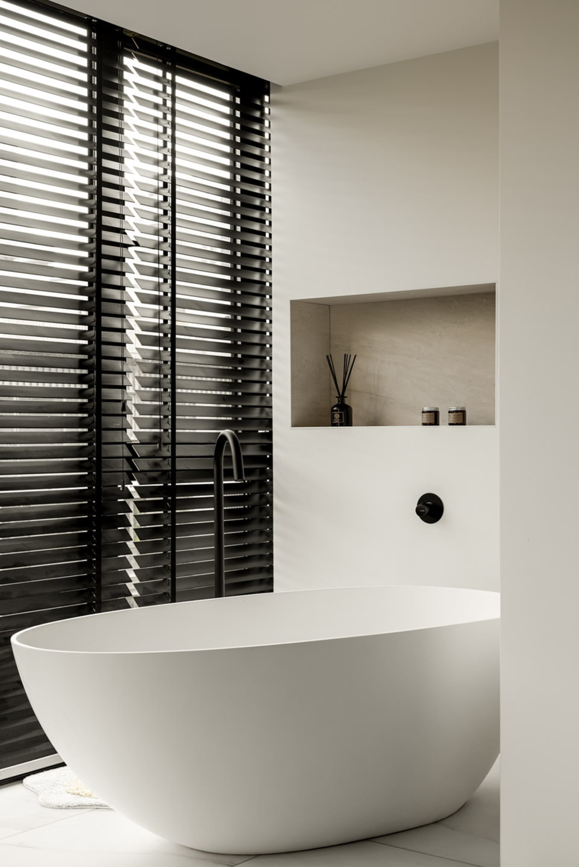Minimalist bathroom with concrete, glass, and black and white decor.